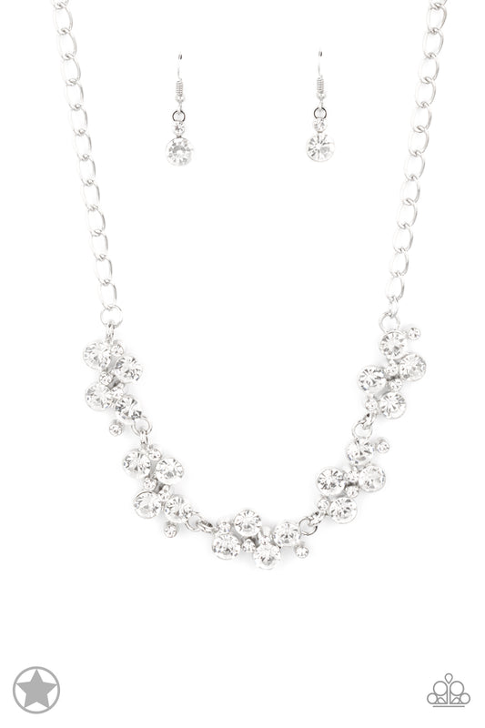 Paparazzi Accessories Hollywood Hills - White A row of dazzling white rhinestones drapes along the neckline, creating a sparkling display. Daintier white rhinestones are sprinkled along the clusters, adding luminous detail to the timeless design. Features