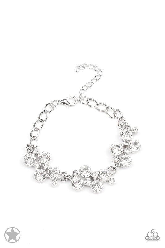 Paparazzi Accessories Old Hollywood Clusters of brilliant white rhinestones drape elegantly along the wrist. The scattered pattern and varying sizes of the rhinestones add breathtaking detail to the piece. Features an adjustable clasp closure. Sold as one