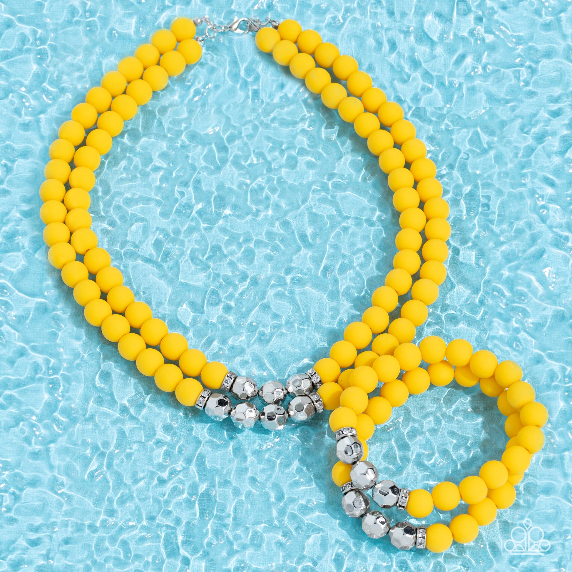 Paparazzi Accessories Summer Splash - Yellow Threaded along invisible wires, matte-finished Daffodil beads give way to center sections of white rhinestone encrusted rings and faceted silver beads. The sunny display layers below the collar, creating a summ
