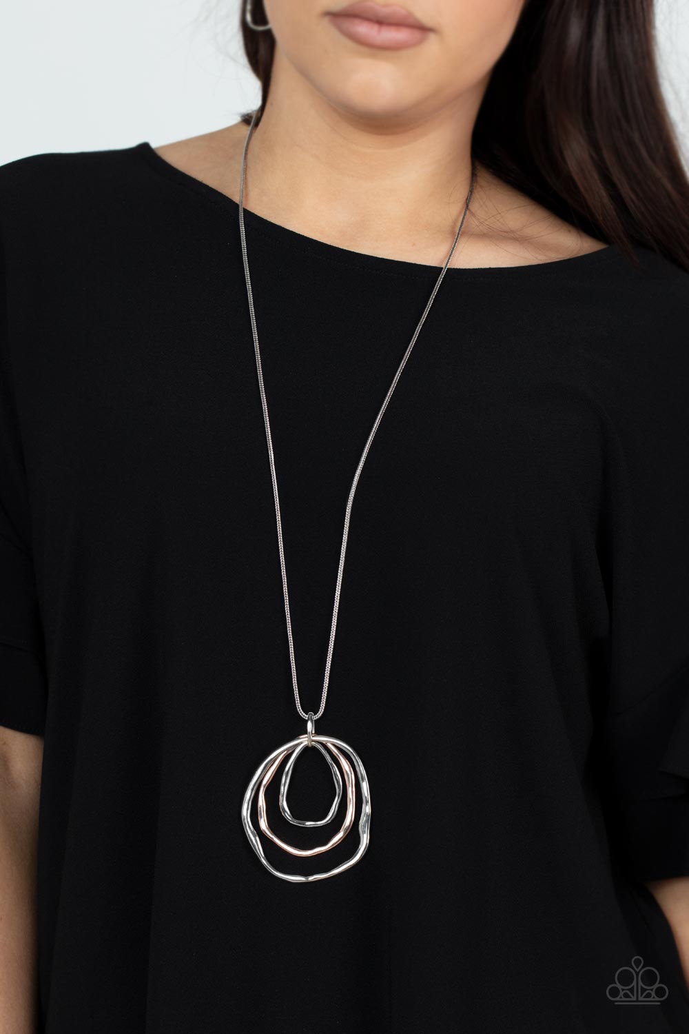 Paparazzi Accessories Revamped Relic - Silver A trio of mismatched warped rose gold and silver rings swing from the bottom of a glistening silver chain, creating an asymmetrically stacked pendant. Features an adjustable clasp closure. Necklaces