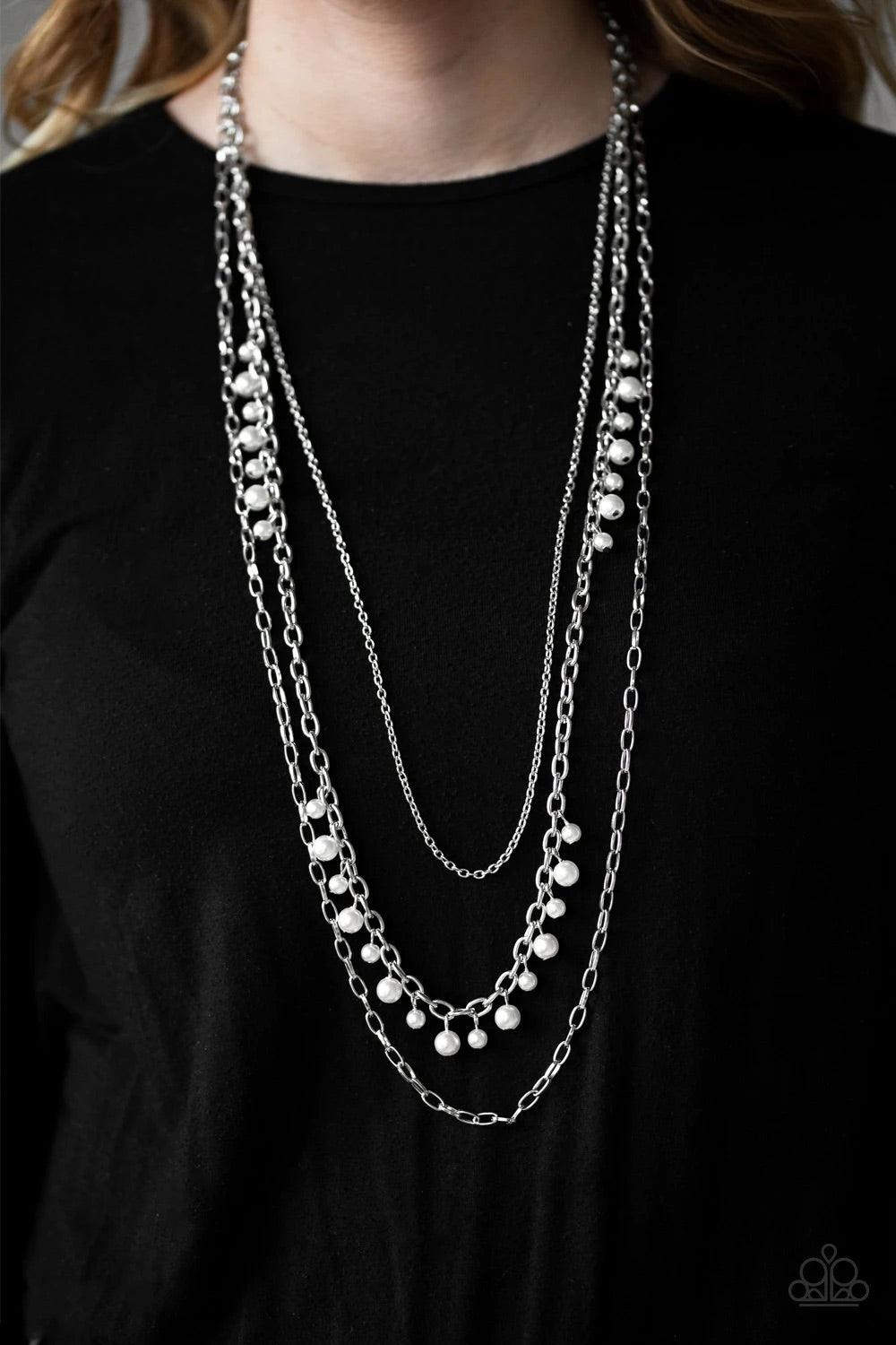 Paparazzi Accessories Pearl Pageant None - White Three mismatched silver chains layer down the chest. Dainty gray pearls cascade down one silver chain, adding a flirty twist to the timeless pearl palette. Features an adjustable clasp closure. Sold as one