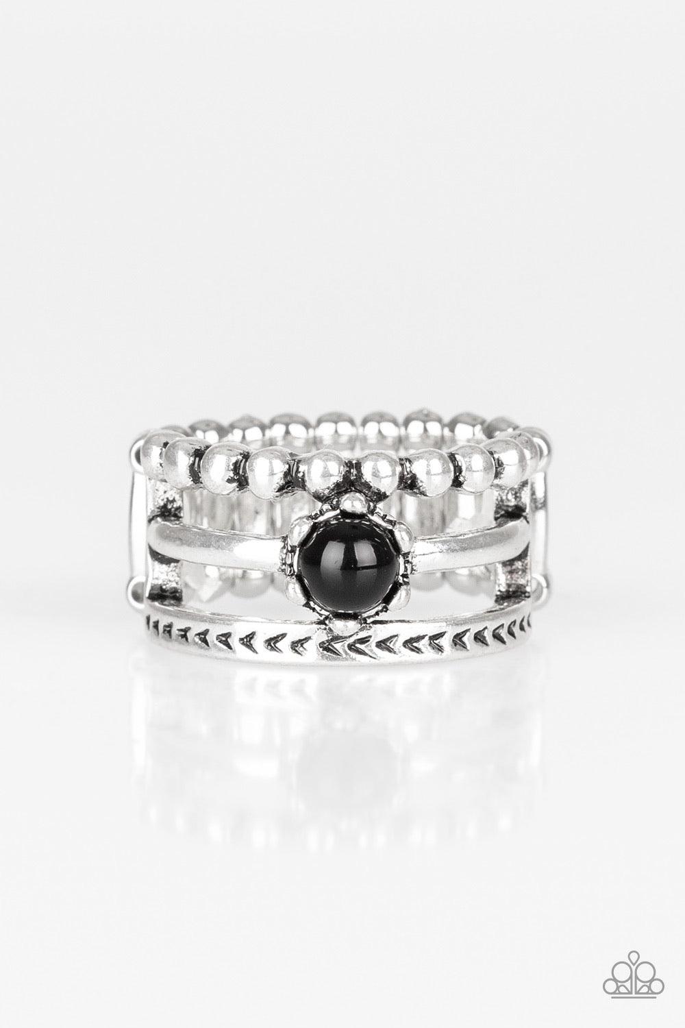 Paparazzi Accessories POP Rival - Black A trio of studded, smooth, and tribal stamped silver bands layer across the finger, coalescing into an airy frame. A shiny black bead is pressed into the center of the shimmery layers for a perfect pop of color. Fea