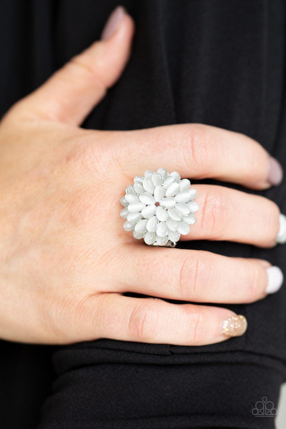 Paparazzi Accessories Bloomin Bloomer - White Row after row of teardrop cat's eye stones stack into a blast of white petals atop the finger, creating a whimsical blossom. Features a stretchy band for a flexible fit. Jewelry