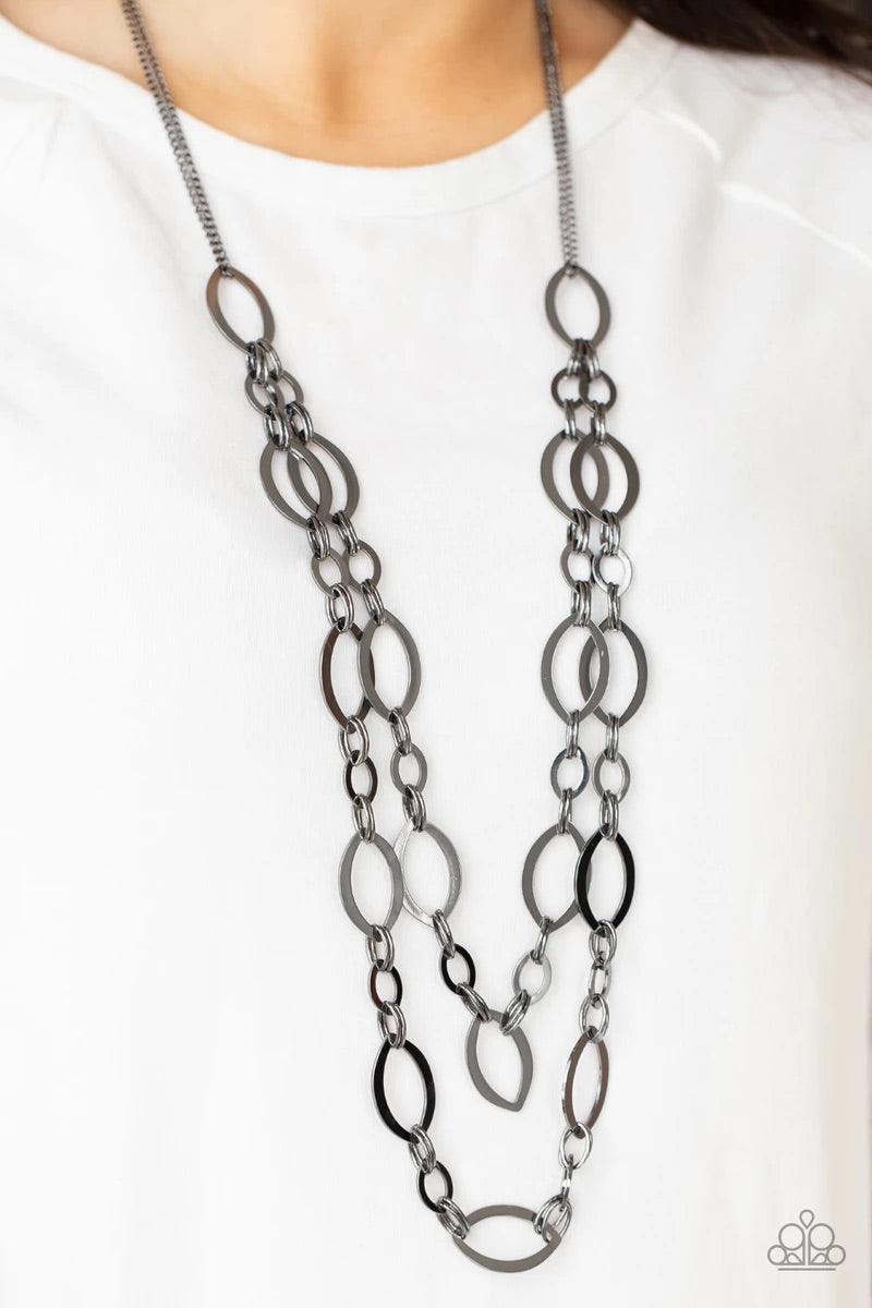 Paparazzi Accessories The OVAL-achiever - Black Stunning gunmetal ellipses link together for two layers of bold, basic drama. The layers hang from a simple gunmetal chain adding balance to the scene. Features an adjustable clasp closure. Sold as one indiv