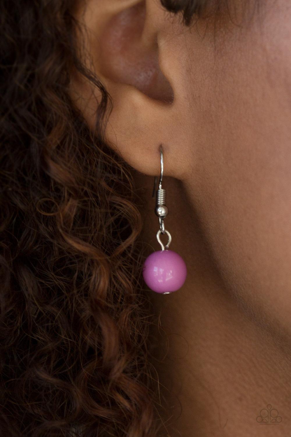 Paparazzi Accessories Hitting a Glow Point - Purple Featuring faceted silver accents, glassy and polished purple beads trickle along strands of shimmery silver chains for a seasonal look. Features an adjustable clasp closure. Jewelry