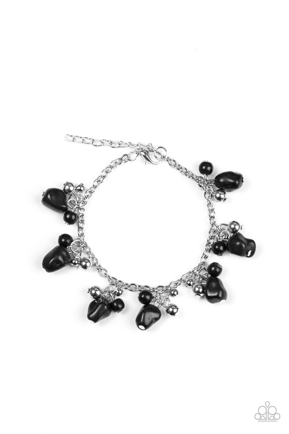 Paparazzi Accessories Mountain Mamba - Black Varying in shape and size, shiny silver beads and earthy black stone beading swing from a shimmery silver chain, creating a colorful fringe around the wrist. Features an adjustable clasp closure. Sold as one in
