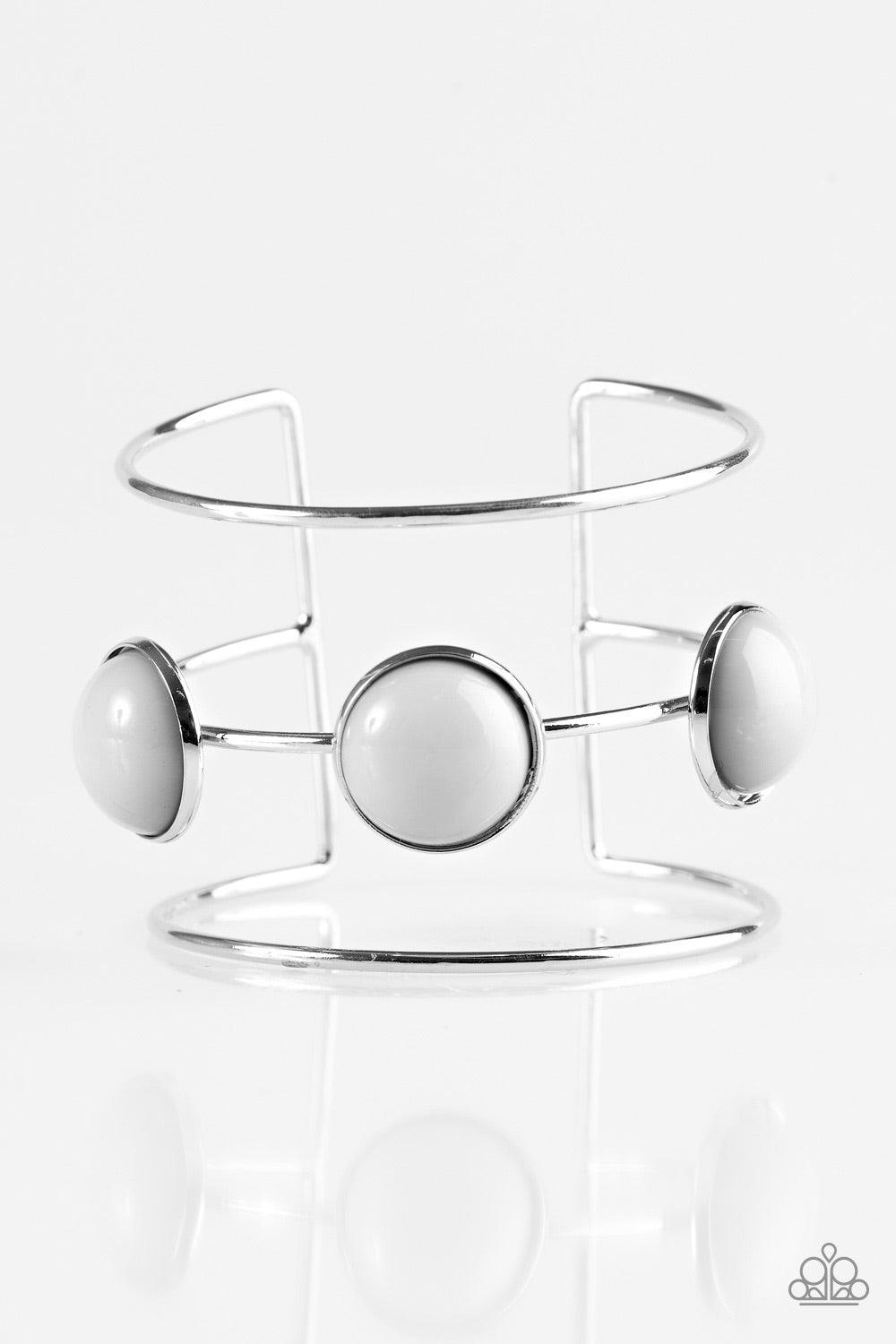 Paparazzi Accessories Lush Lagoon - Silver Three shimmery silver bars arc across the wrist, coalescing into an airy cuff. Three neutral gray beads are pressed into the centermost bar for a bubbly finish. Jewelry