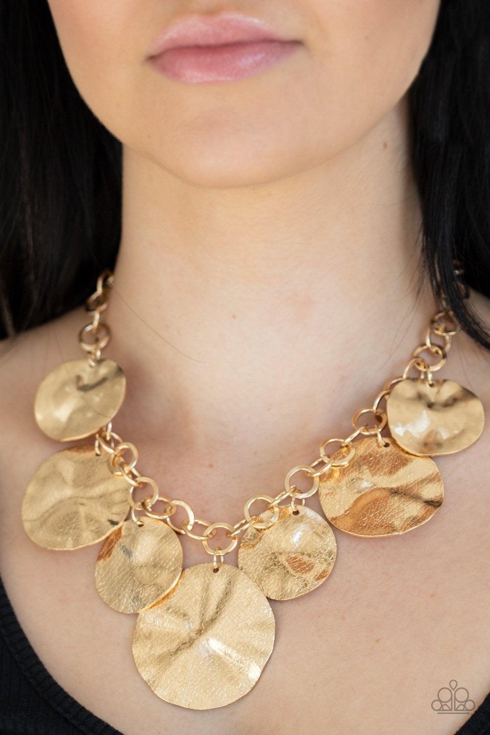 Paparazzi Accessories Barely Scratched The Surface - Gold Scratched in shimmer, warped gold discs swing from the bottom of a thick gold chain, creating a bold fringe below the collar. Features an adjustable clasp closure. Sold as one individual necklace.