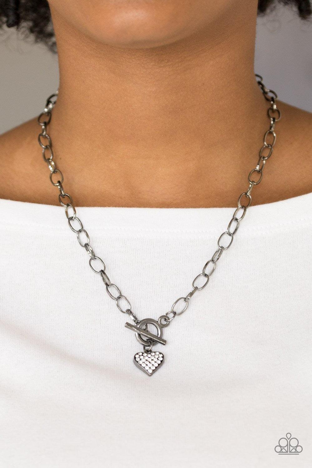Paparazzi Accessories Harvard Hearts - Black Encrusted in glassy white rhinestones, a dainty gunmetal heart swings from the bottom of a glistening gunmetal chain for a classic look. Features a toggle closure. Jewelry