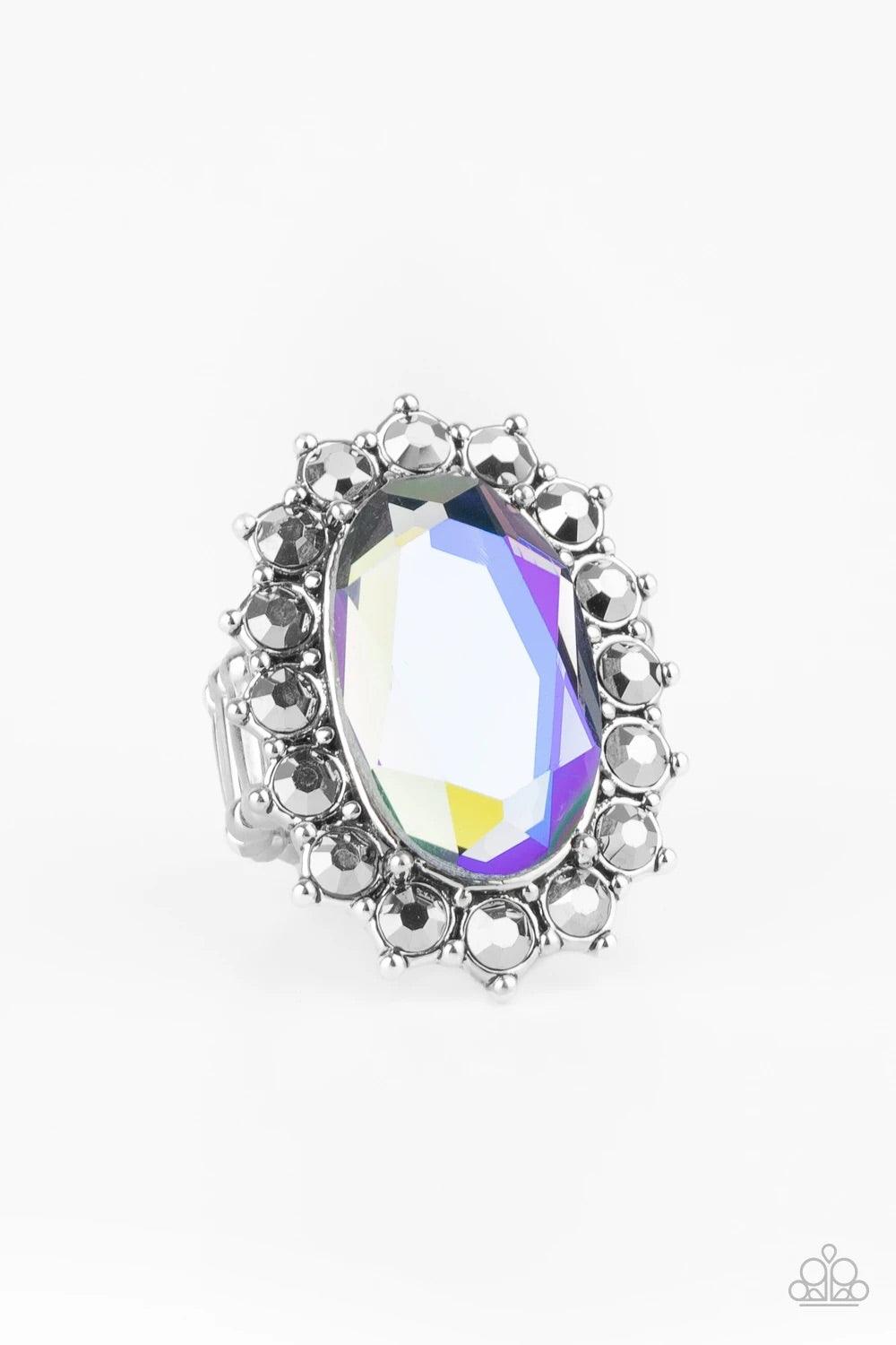 Paparazzi Accessories Bling of All Bling - Multi Hematite rhinestone encrusted petals bloom from an oversized iridescent blue gem, creating a dramatic centerpiece atop the finger. Features a stretchy band for a flexible fit. Sold as one individual ring. J