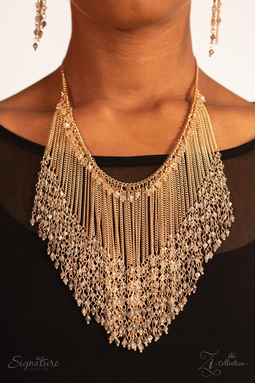 Paparazzi Accessories The DonnaLee Countless gold chains stream from the bottom of a glistening gold chain, creating a curtain of show-stopping fringe that falls just below the collar. Faceted crystal-like beading lays across the top of the cascading chai