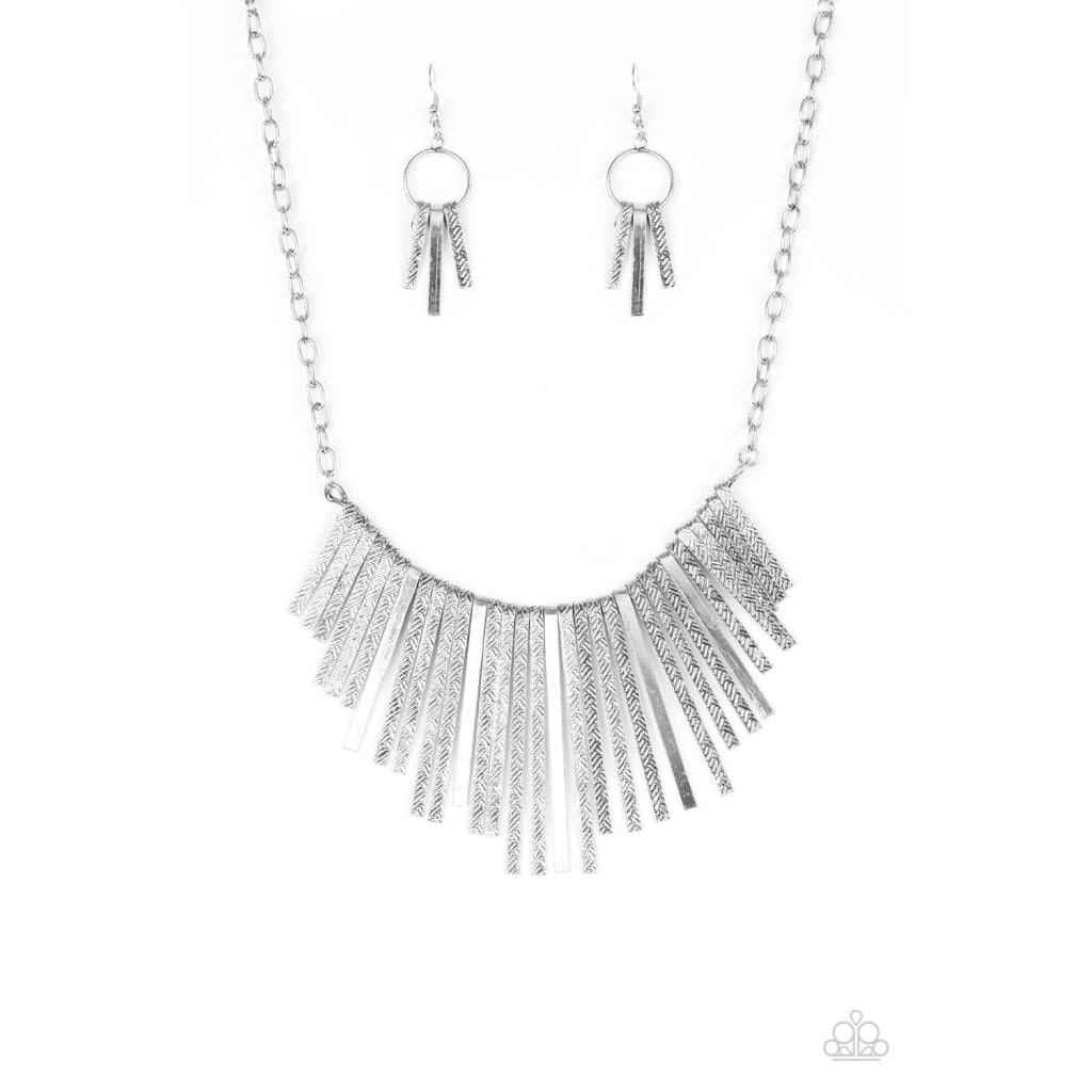Paparazzi Accessories Welcome To The Pack - Silver Embossed in edgy linear patterns, flat silver rods alternate with plain silver rods below the collar, creating a fiercely tapered fringe. Features an adjustable clasp closure. Sold as one individual neckl