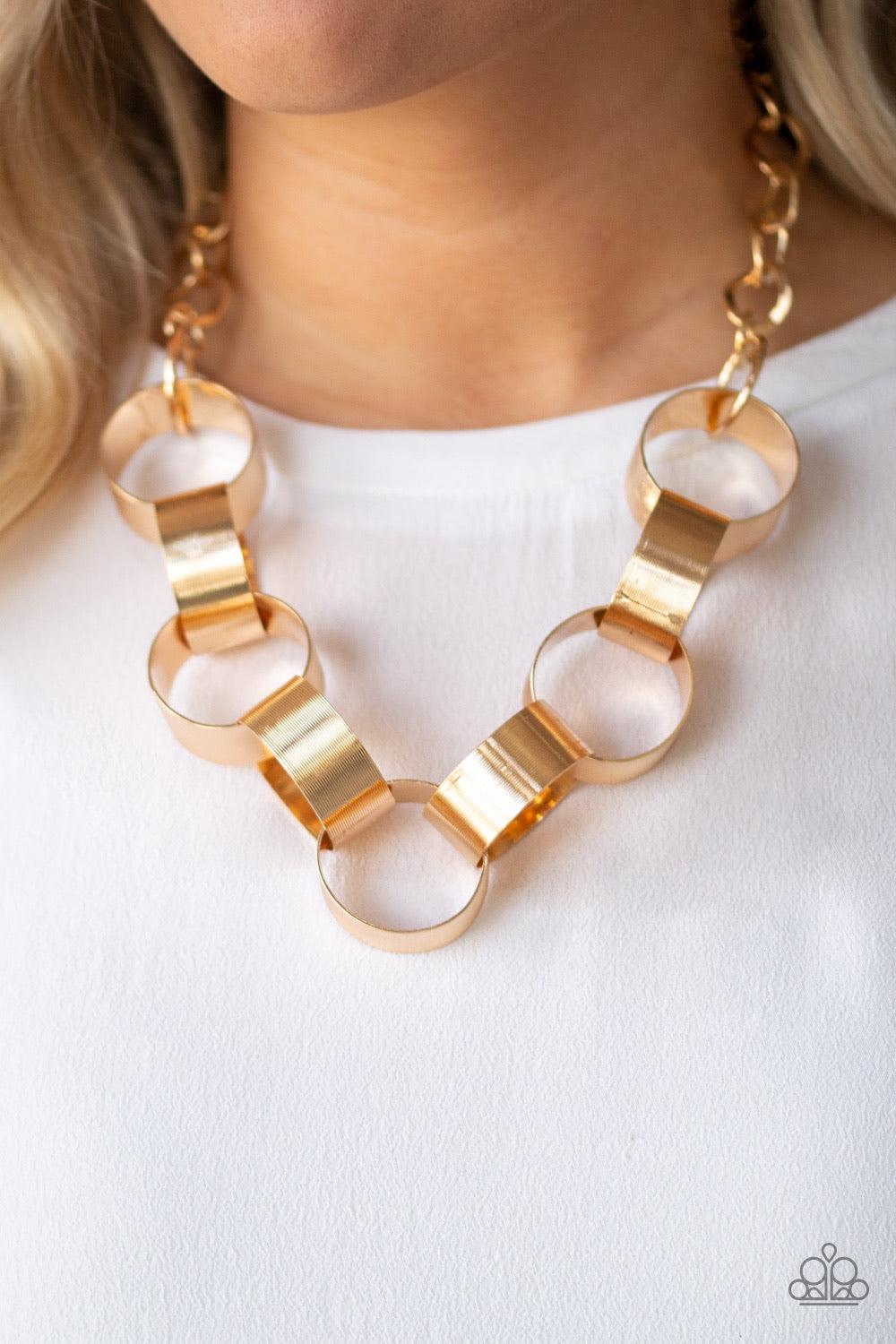 Paparazzi Accessories Big Hit - Gold Etched in linear patterns, dramatically oversized gold links connect below the collar for a bold statement-making look. Features an adjustable clasp closure. Jewelry