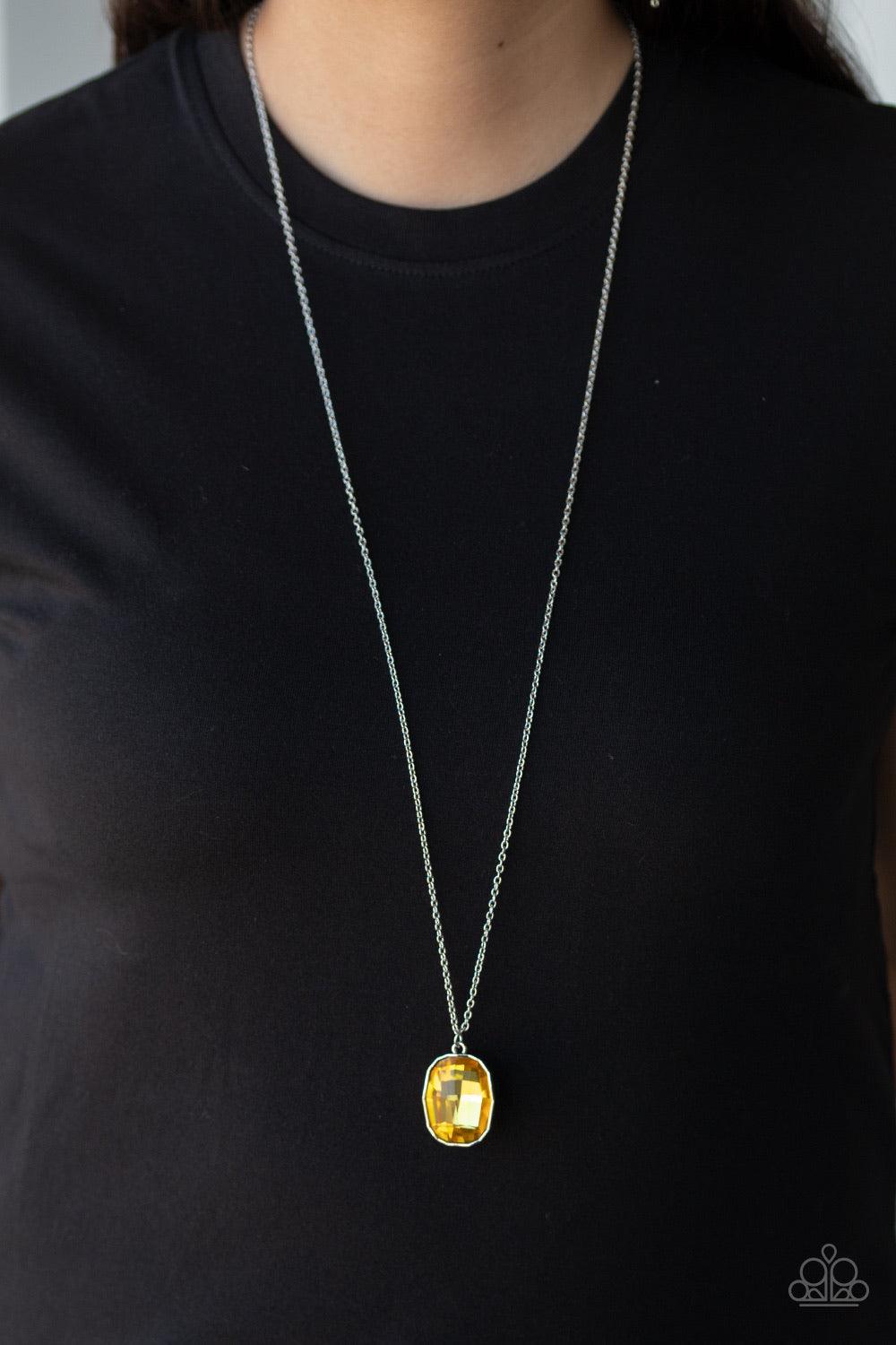 Paparazzi Accessories Imperfect Iridescent - Yellow An imperfect yellow gem is pressed into the center of an edgy silver frame at the bottom of a lengthened silver chain for a glitzy look. Features an adjustable clasp closure. Sold as one individual neckl