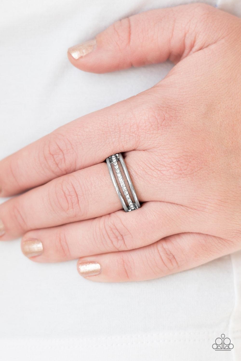 Paparazzi Accessories Center Court - White Dainty silver bands layer across the finger. The centermost band is encrusted in white rhinestones for a glamorous finish. Features a dainty stretchy band for a flexible fit. Jewelry