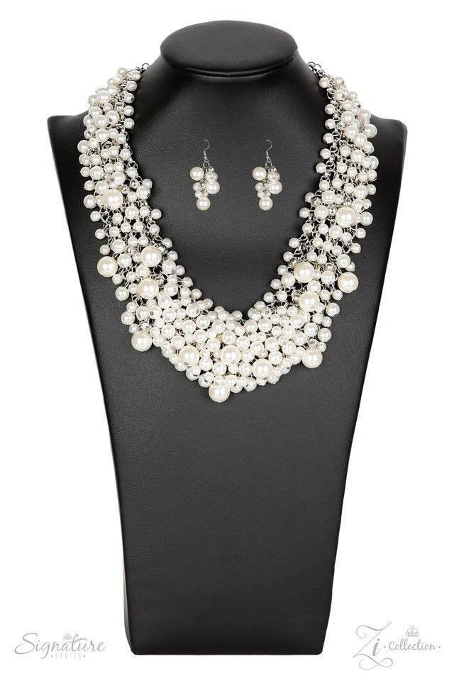 Paparazzi Accessories The Tracey Varying in size, countless white pearls cascade from a web of thick silver chain, creating a bubbly fringe that falls just below the collar. Classic white rhinestones are nestled among the endless sea of pearls, adding hin