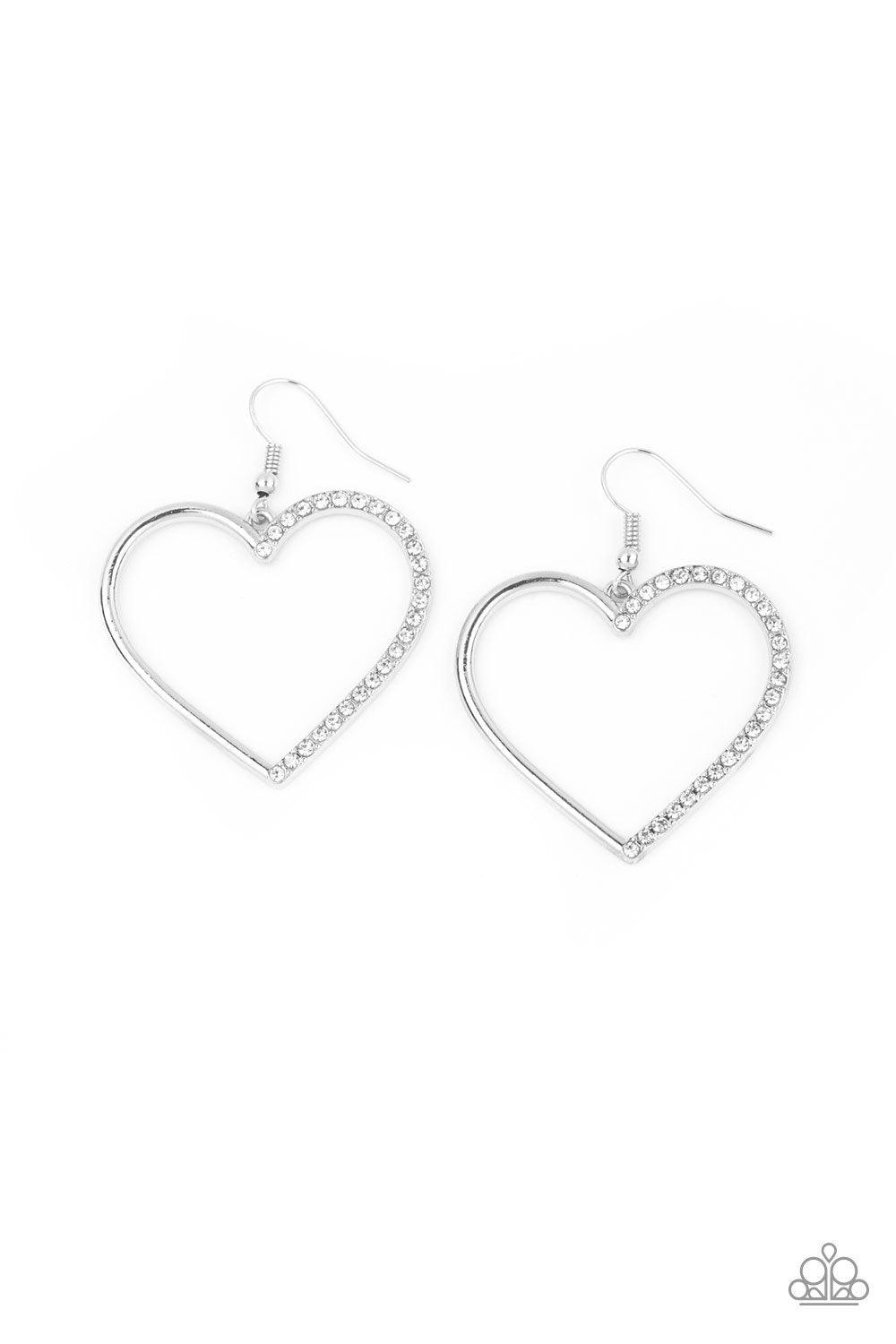 Paparazzi Accessories First Date Dazzle - White One half of a shimmery silver heart silhouette has been encrusted in glassy white rhinestones, creating a charming frame. Earring attaches to a standard fishhook fitting. Sold as one pair of earrings. Jewelr