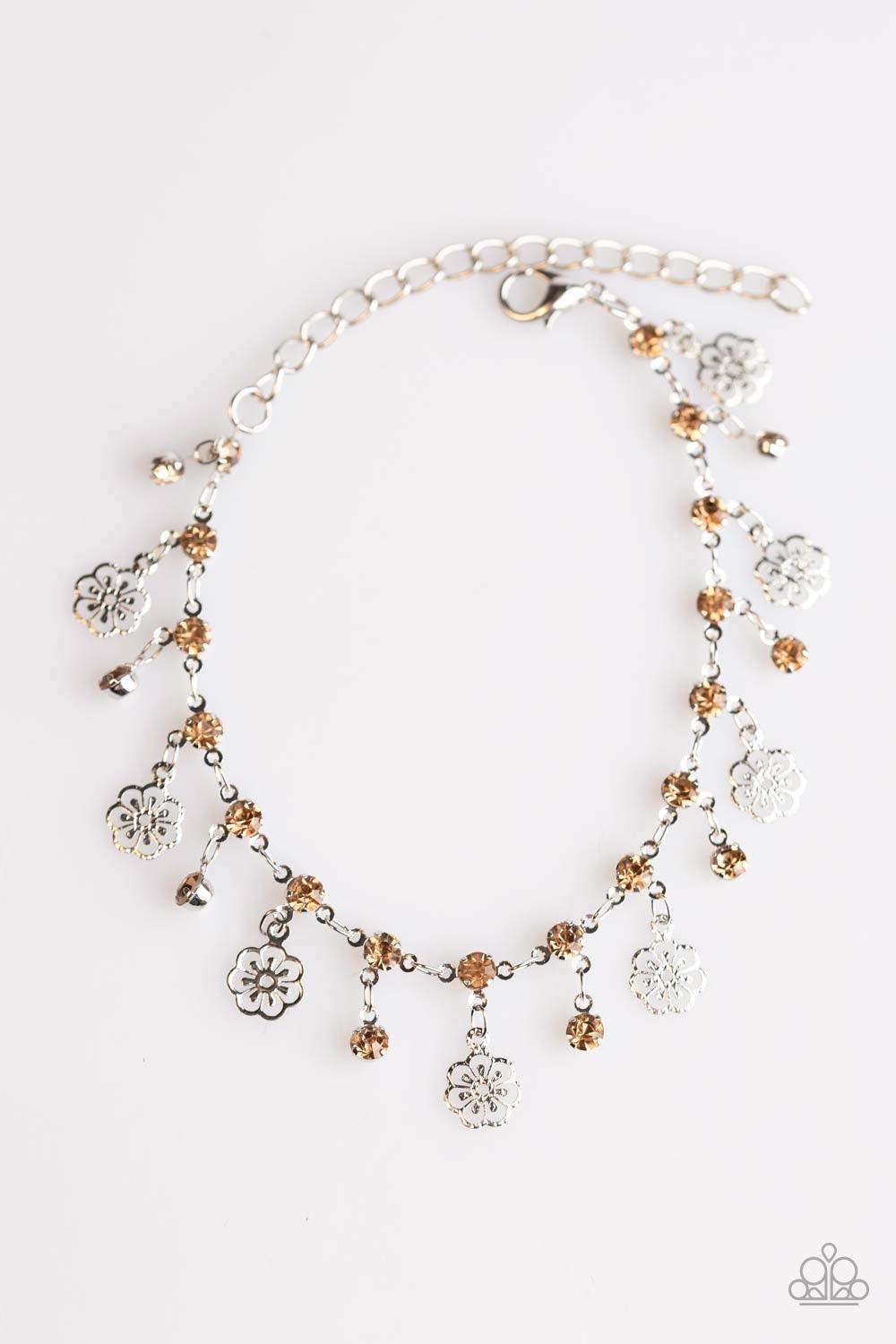 Paparazzi Accessories Hibiscus Breeze - Brown Dainty silver flower charms swing from the wrist in a whimsical fashion. Glittery topaz rhinestones fall between the tropical flowers for a sparkling finish. Features an adjustable clasp closure. Jewelry