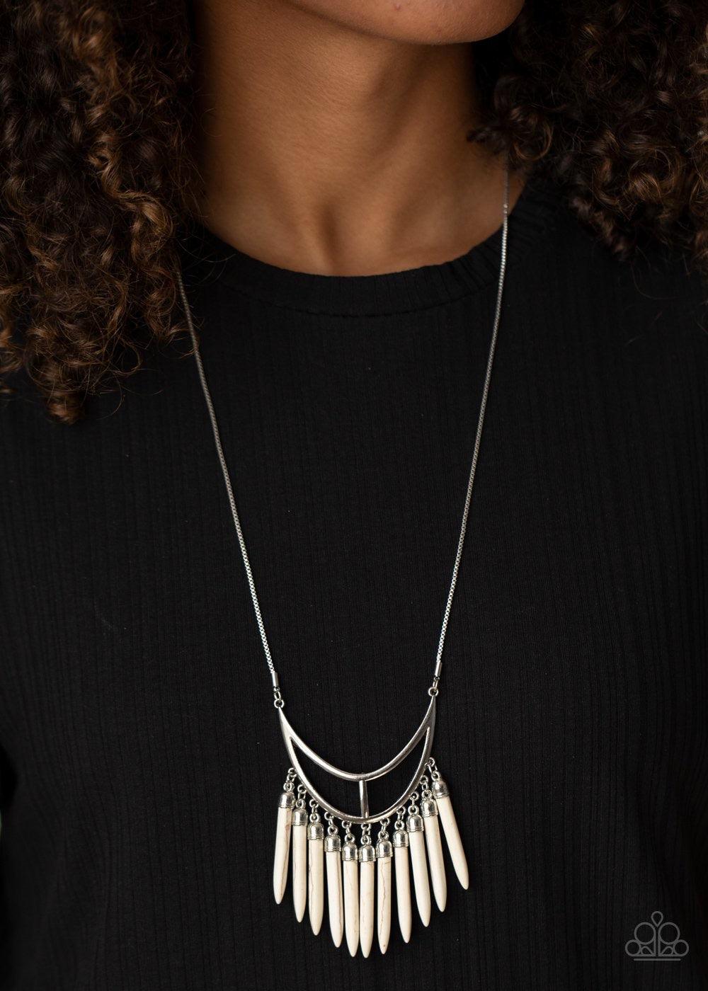 Paparazzi Accessories Stone Age A-Lister - White Capped in dainty silver fittings, refreshing white stone tusk-like bars dangle from the bottom of an airy silver crescent frame, creating an earthy fringe at the bottom of a lengthened silver chain. Feature