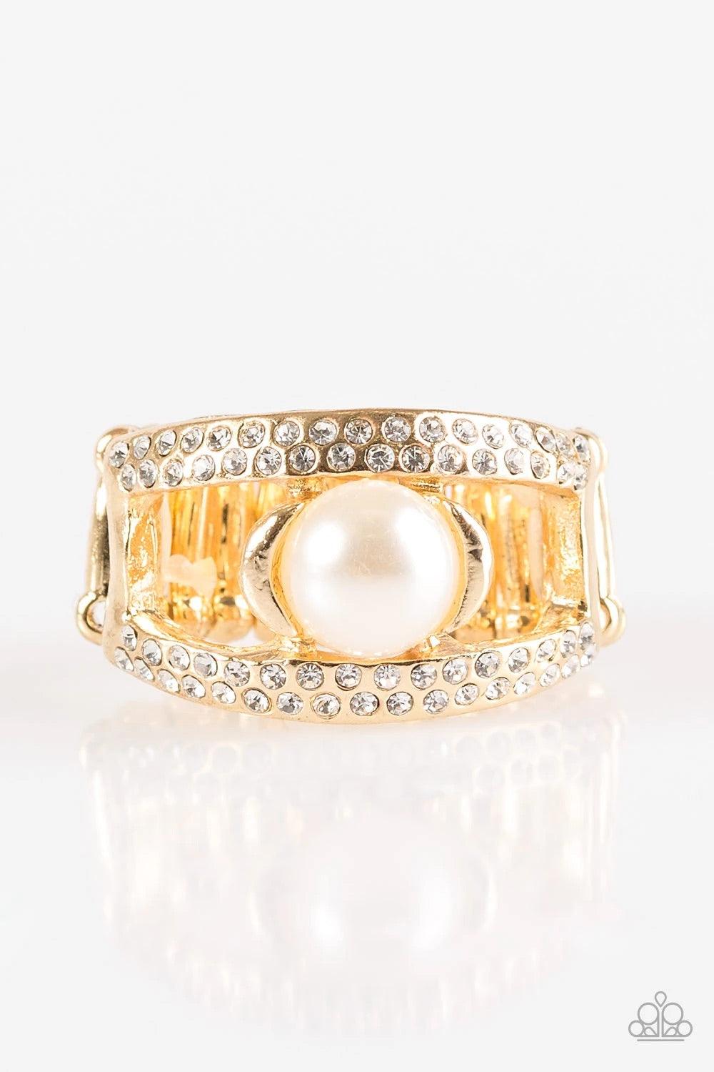 Paparazzi Accessories Bank Run - Gold Encrusted in glassy white rhinestones two glistening gold ribbons arc across the finger. Infused with a sleek gold fitting, a classic white pearl is pressed into the center of the bands for a refined finish. Features