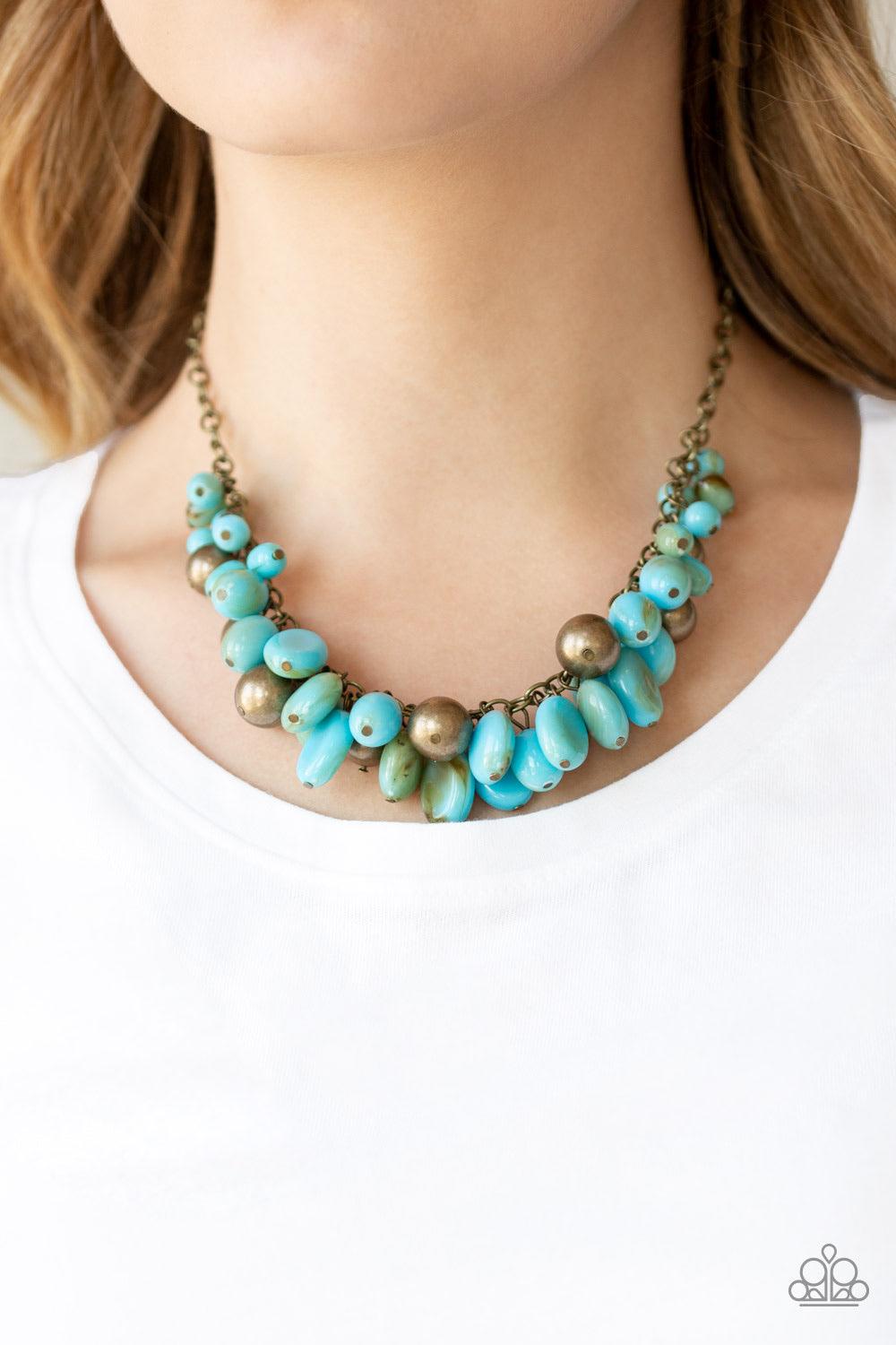 Paparazzi Accessories Full Out Fringe - Blue Featuring a smoky finish, a collection of blue acrylic beads and antiqued brass beads dangle from a classic brass chain, creating a flirtatiously clustered fringe below the collar. Features an adjustable clasp