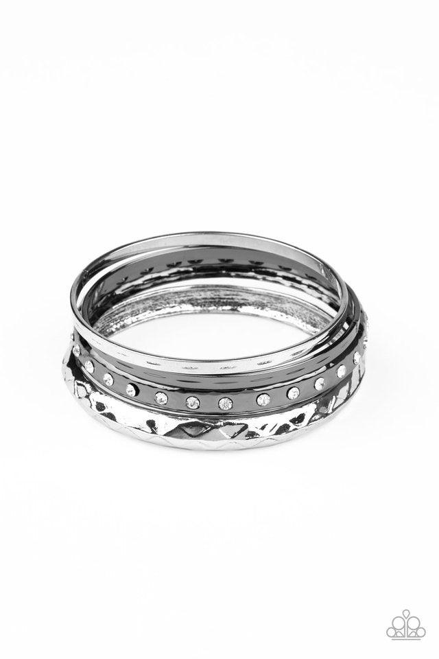 Paparazzi Accessories Revved Up Rhinestones - Multi A mismatched stack of gunmetal and silver bangles are hammered in texture, creating light-catching edges that reflect an immense amount of shine. One bangle is lined with glassy white rhinestones, adding