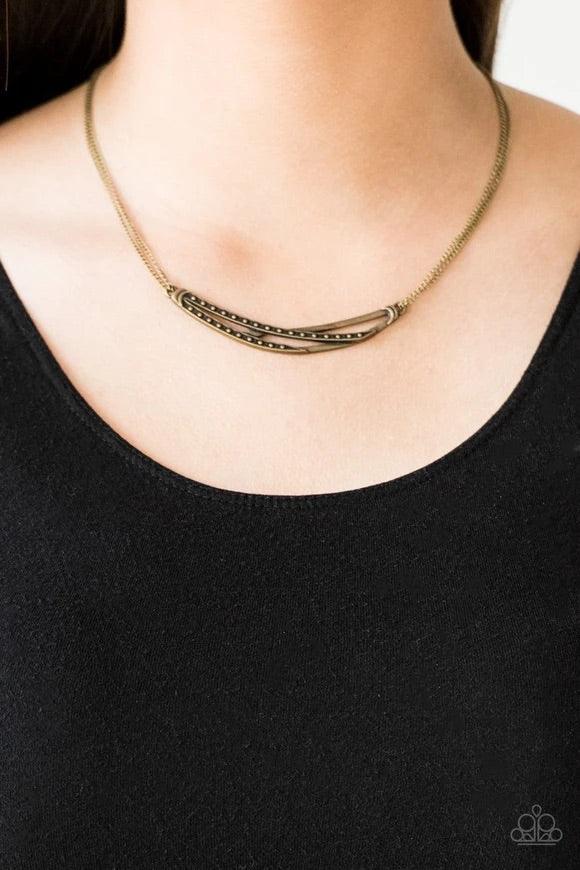 Paparazzi Accessories Moro Modern - Brass Dotted and hammered brass bars crisscross below the collar, coalescing into an edgy crescent-shaped pendant. Features an adjustable clasp closure. Sold as one individual necklace. Includes one pair of matching ear