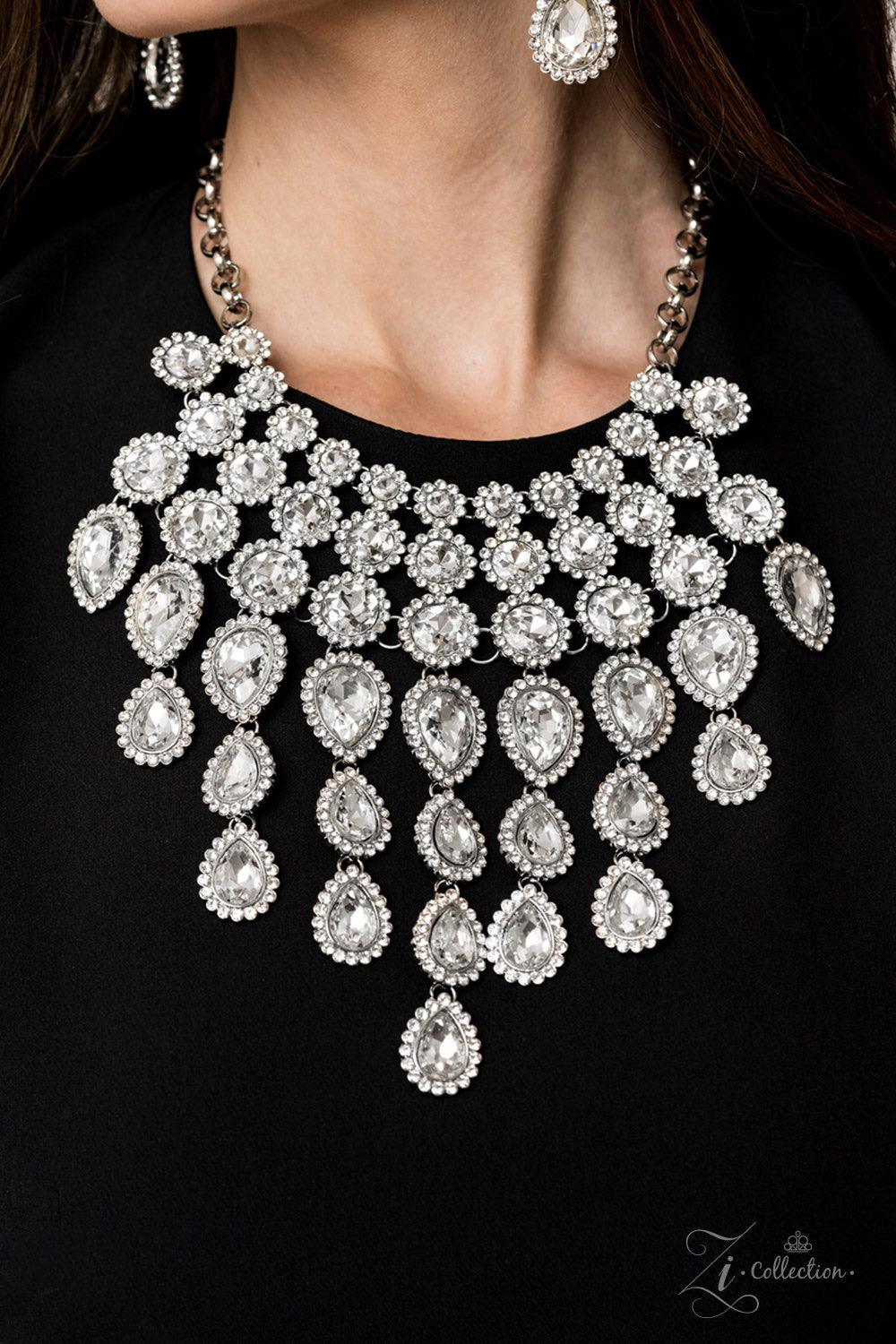 Paparazzi Accessories Mesmerize 💗ZiCollection $25💗 Encrusted in dainty white rhinestone frames, columns of glassy white gem studded frames increase in size as they drip below the collar. Varying in size and number, white rhinestone encrusted teardrop ge