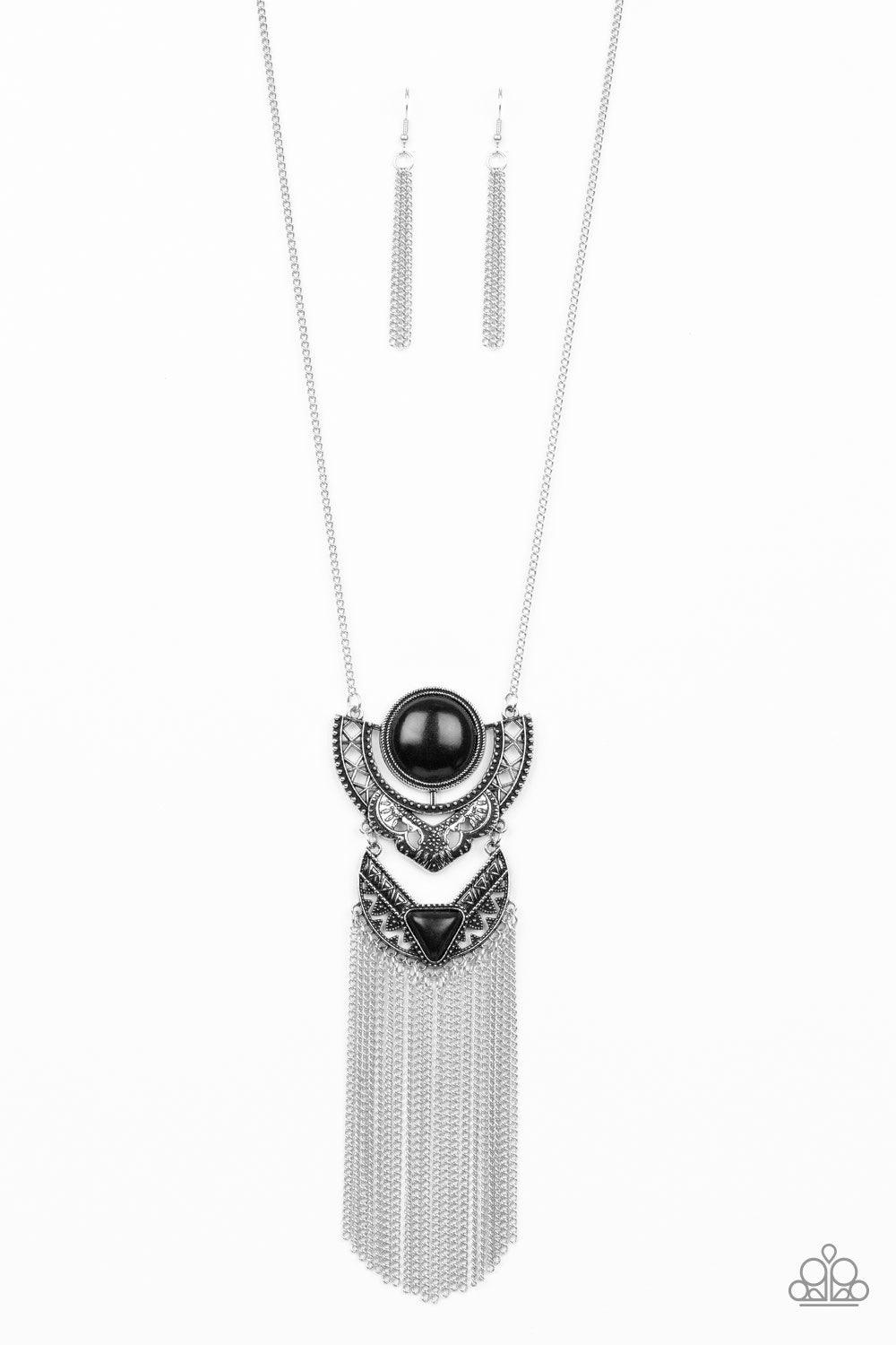 Paparazzi Accessories Spirit Trek - Black Featuring earthy black stone accents, ornate silver plates link at the bottom of a lengthened silver chain for a dramatic tribal look. Shimmery silver chains stream from the bottom of the stacked pendant, adding a