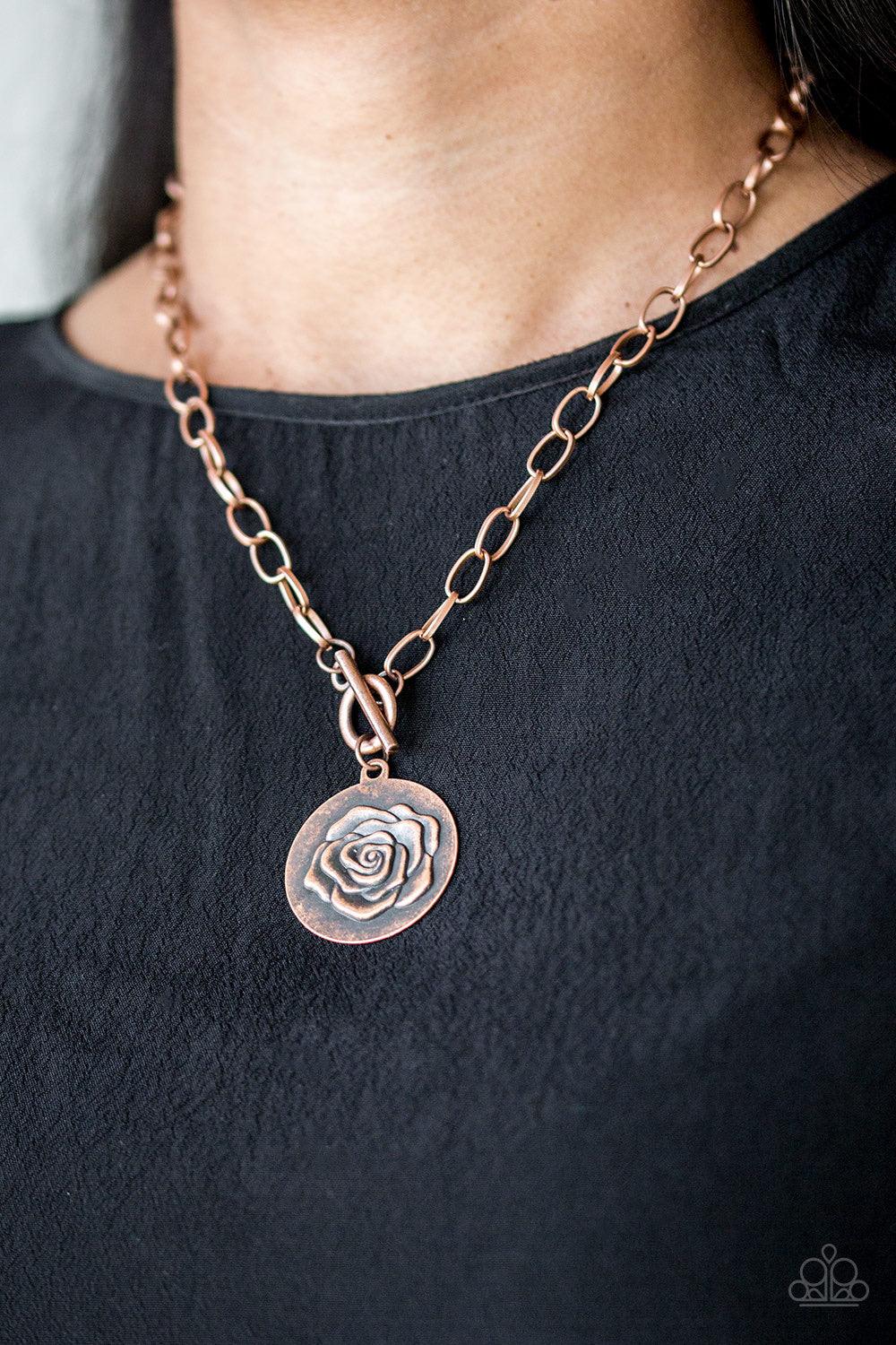 Paparazzi Accessories Beautifully Belle - Copper Embossed in a whimsical rosebud pattern, a shimmery copper frame swings below the collar for a casual look. Features a toggle closure. Sold as one individual necklace. Includes one pair of matching earrings