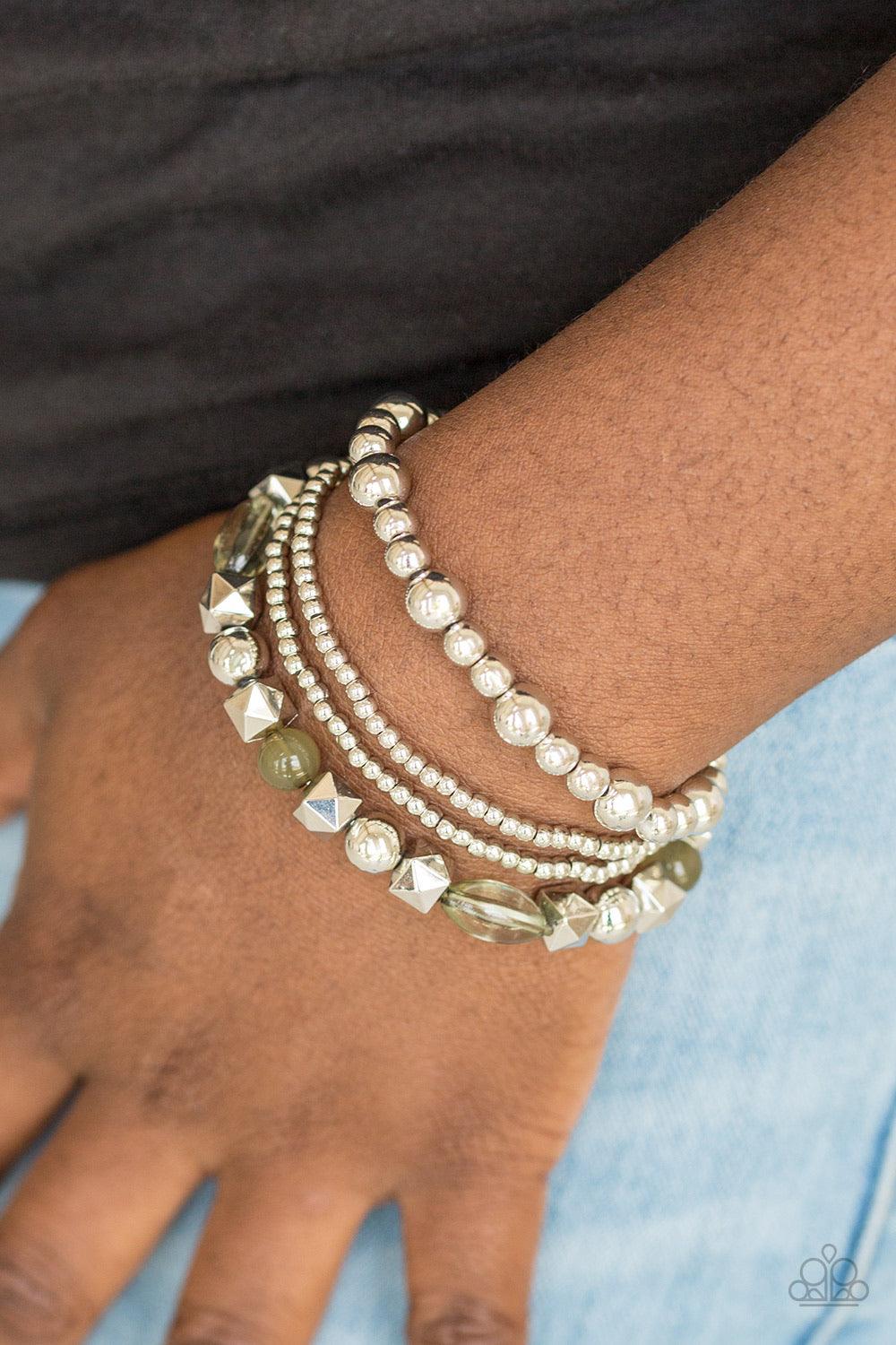 Paparazzi Accessories Babe-alicious - Green Mismatched silver beads and glassy green beads are threaded along stretchy bands, creating colorful layers across the wrist. Sold as one set of four bracelets. Jewelry