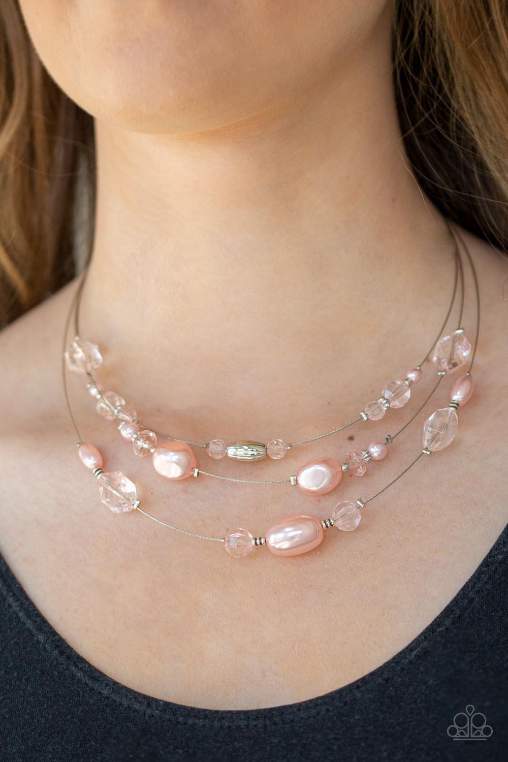 Paparazzi Accessories Pacific Pageantry - Pink An elegant collection of pearly pink, dainty silver, and pink crystal-like beads are fitted in place along three silver wires below the collar, creating the illusion of floating layers. Features an adjustable
