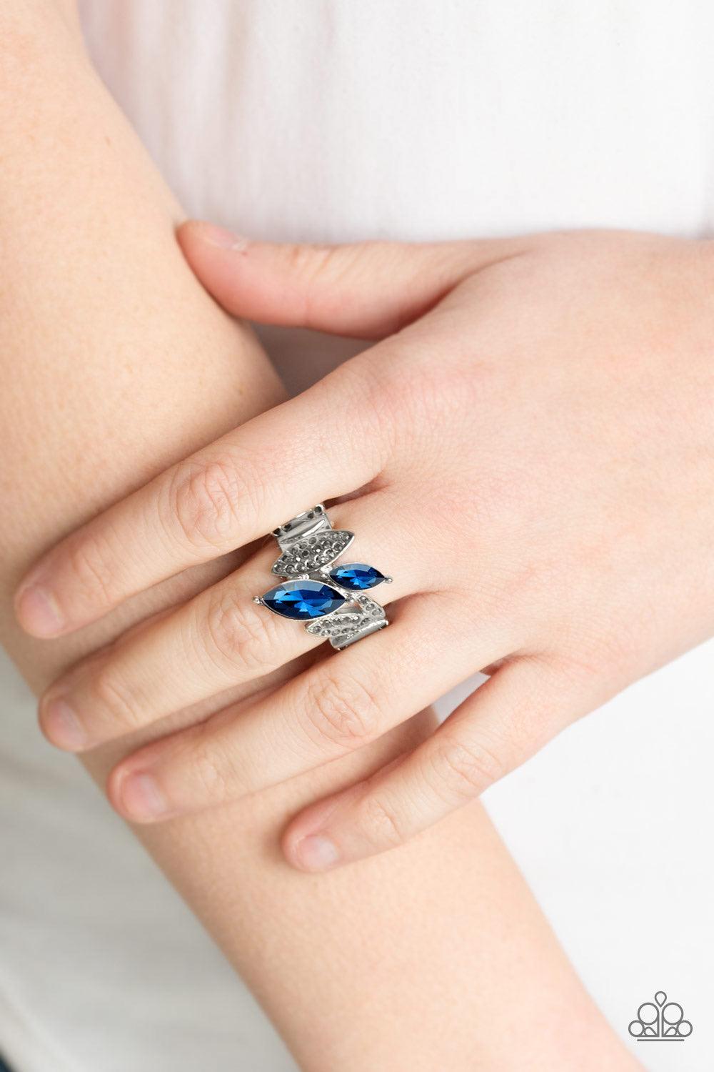Paparazzi Accessories Stay Sassy - Blue Featuring elegant marquise style shapes, hematite rhinestone encrusted silver frames and glittery blue rhinestones connect across the finger for an edgy-glamorous look. Features a stretchy band for a flexible fit. S