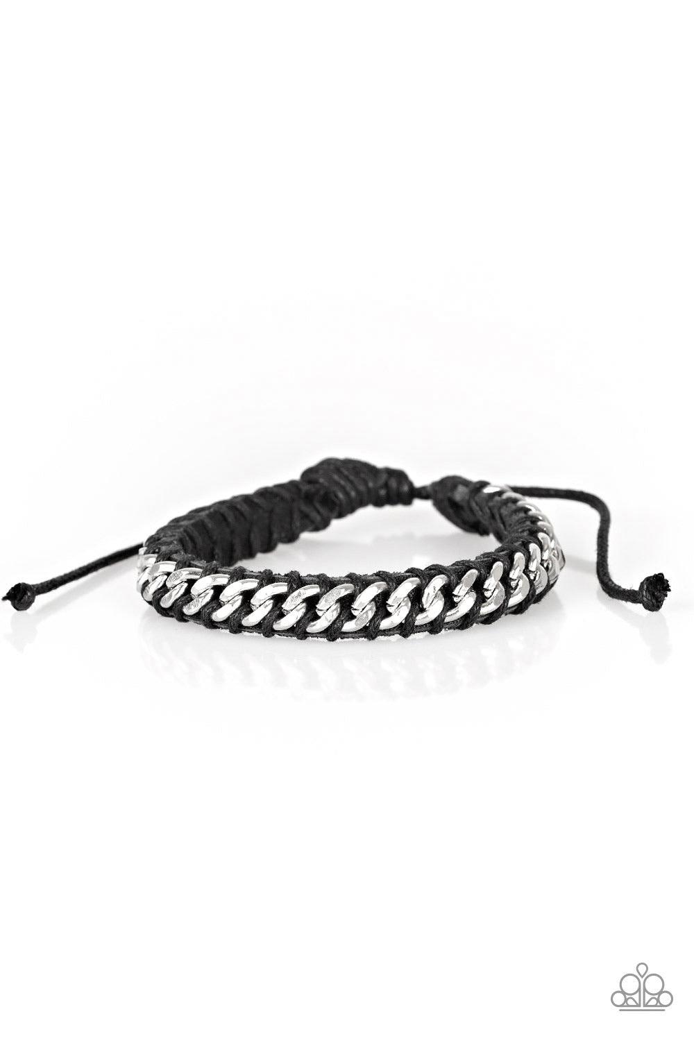 Paparazzi Accessories Rugged Ranger - Black Black cording knots a shimmery silver chain across the front of a black leather band for a rugged look. Features an adjustable sliding knot closure. Jewelry