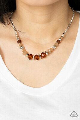 Paparazzi Accessories Turn Up The Tea Lights - Brown A fiery collection of red teardrop stones fan out from a textured silver ring, creating a scalloped floral frame at the bottom of a round red stone dotted frame. Earring attaches to a standard fishhook