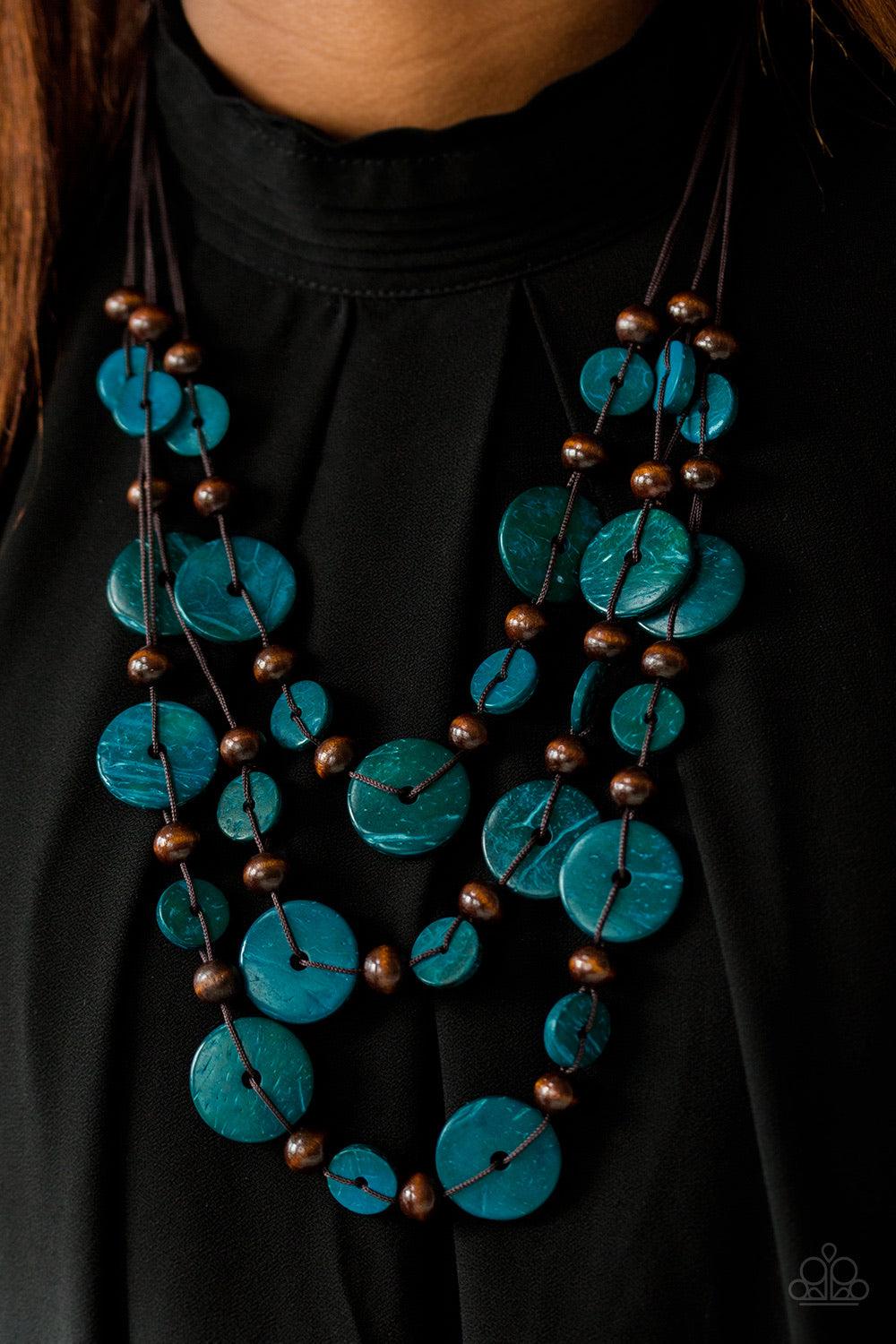 Paparazzi Accessories South Beach Summer - Blue Brushed in a distressed finish, blue and brown wooden beads trickle along three strands, creating a summery look down the chest. Features a button loop closure. Jewelry