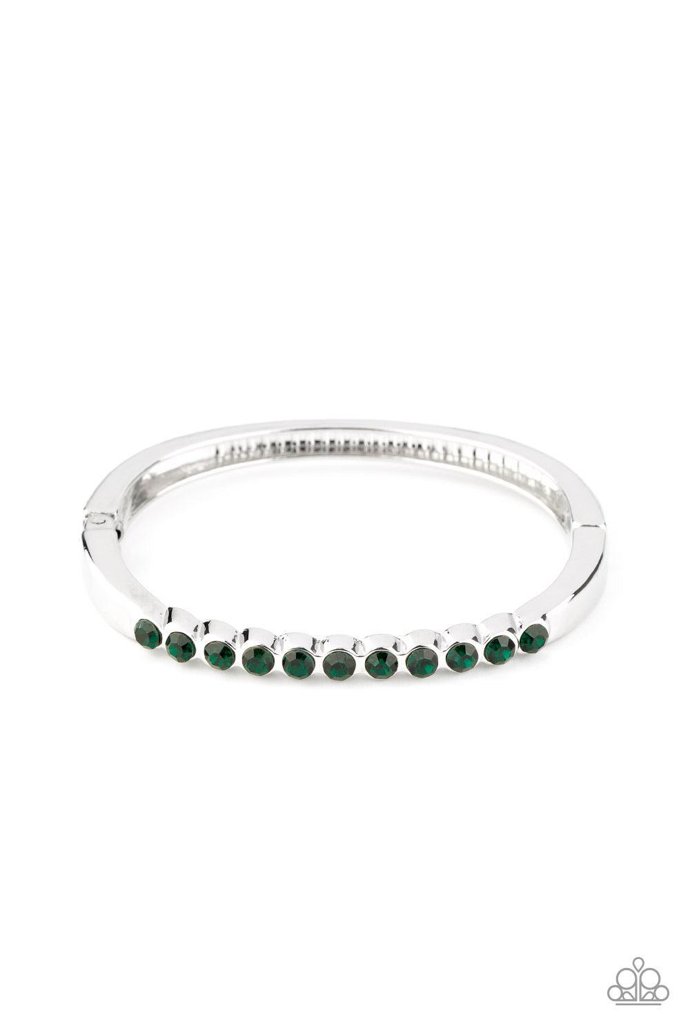Paparazzi Accessories Stellar Beam ~Green A row of glittery green rhinestones is encrusted across the top of a dainty silver cuff-like bracelet for a gorgeous finish. Features a hinged closure. Sold as one individual bracelet. Jewelry