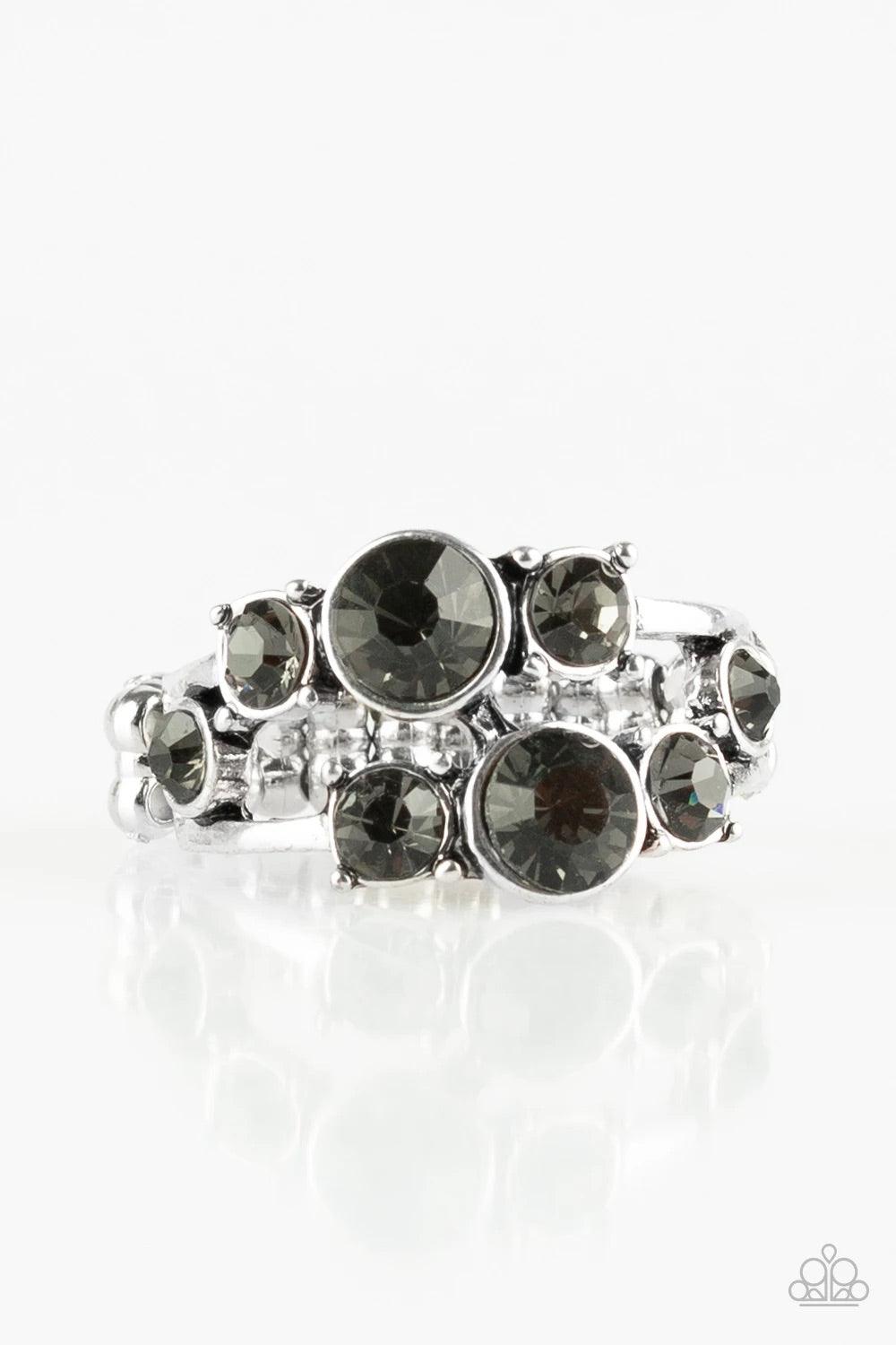 Paparazzi Accessories Interstellar Fashion - Silver Rows of smoky rhinestones connect across the finger, coalescing into a glamorous band. Features a dainty stretchy band for a flexible fit. Sold as one individual ring. Rings