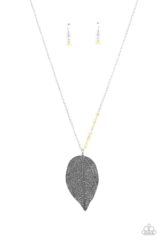 Paparazzi Accessories Frond Fantasy - Yellow One side of a lengthened silver chain is dotted in dainty Illuminating crystal-like beads as it gives way to an oversized leaf pendant embossed in lifelike textures for a seasonal finish. Features an adjustable