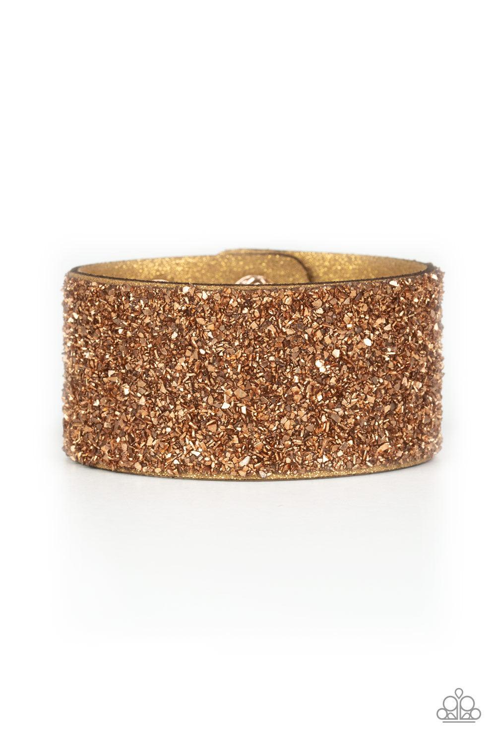 Paparazzi Accessories The Halftime Show - Gold Crushed bits of rose gold accents are sprinkled along the center of a glittery suede band, creating a blinding shimmer around the wrist. Features an adjustable snap closure. Jewelry