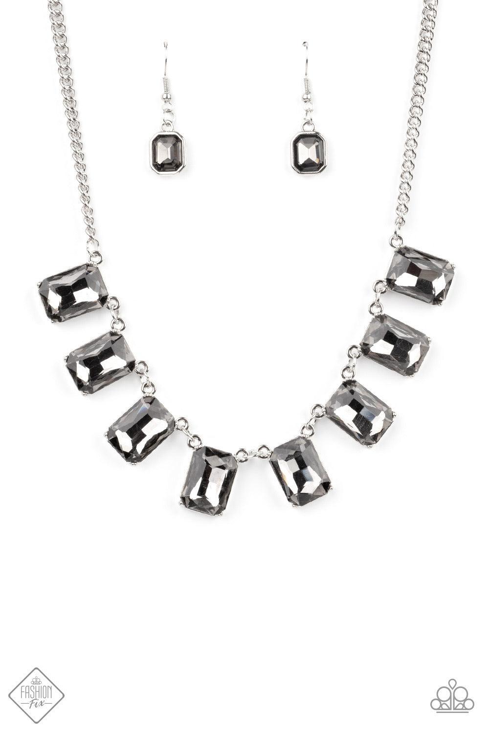Paparazzi Accessories After Party Access - Silver Encased in sleek silver fittings, a regal chain of oversized smoky emerald-cut gems fans out below the collar in a dramatic finish. Features an adjustable clasp closure. Sold as one individual necklace. In