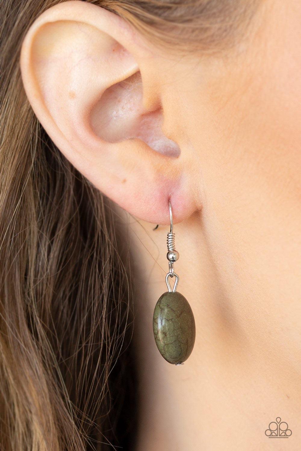 Paparazzi Accessories Island Queen - Green Featuring a collision of hammered, studded, and embossed patterns, two silver half-moon plates dramatically stack below the collar. Swirling with studded filigree detail, ornate silver frames swing from the botto