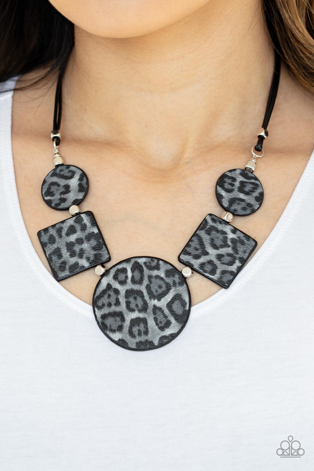 Paparazzi Accessories Here Kitty Kitty - Silver Featuring textured gray cheetah print, a wild collection of circle and square leather pieces are threaded along an invisible wire below the collar for a fierce look. Features an adjustable clasp closure. Sol