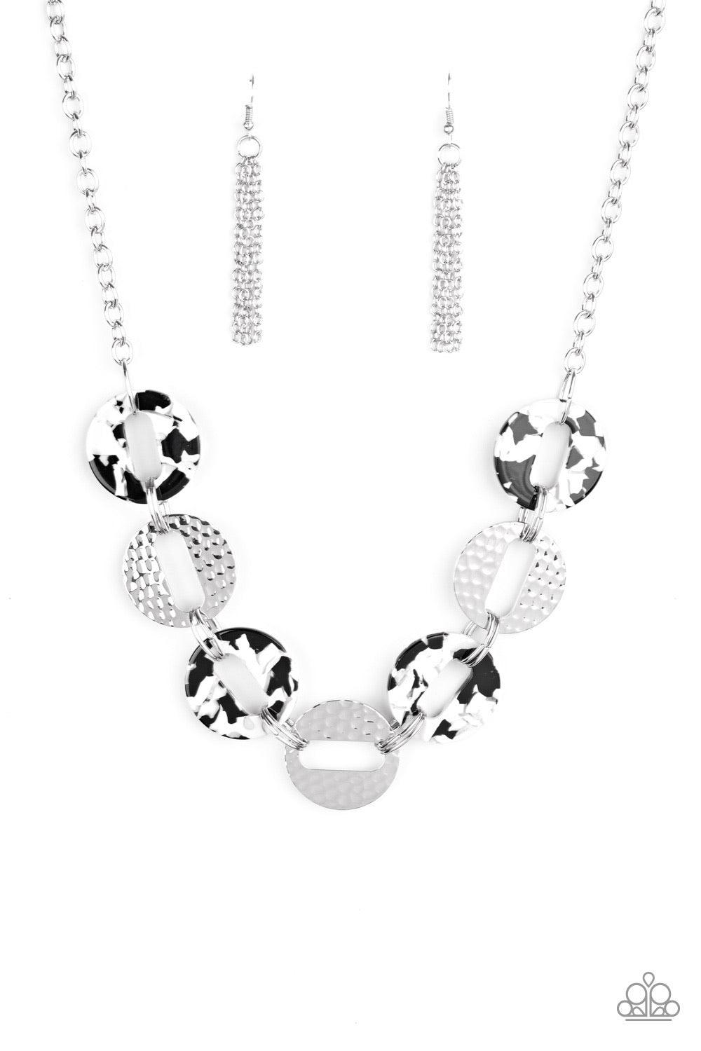 Paparazzi Accessories Retro Retrograde - White Featuring airy circular shapes, hammered silver frames link with speckled black and white acrylic frames below the collar for a colorfully retro look. Features an adjustable clasp closure. Sold as one individ