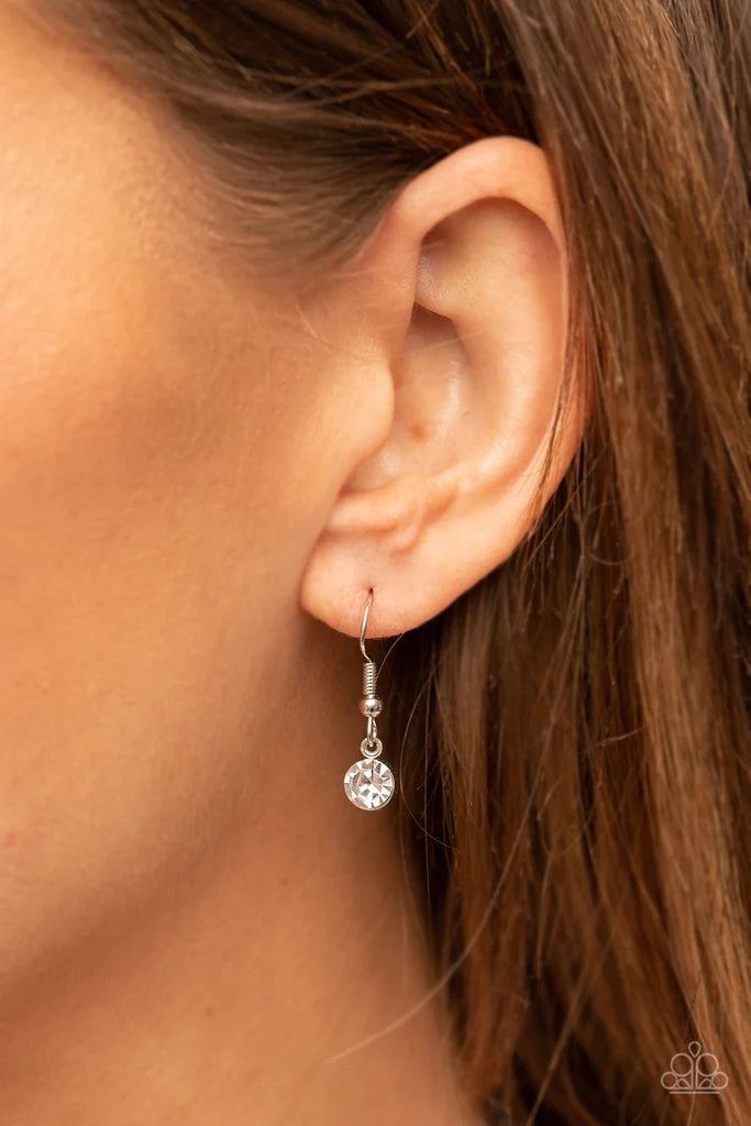 Paparazzi Accessories Finding My Forever - Red Bordered in a ribbon of glassy white rhinestones, an oversized red heart-shaped gem seemingly floats at the bottom of an extended silver chain. A shimmery silver chain tassel dances from the bottom of the spa
