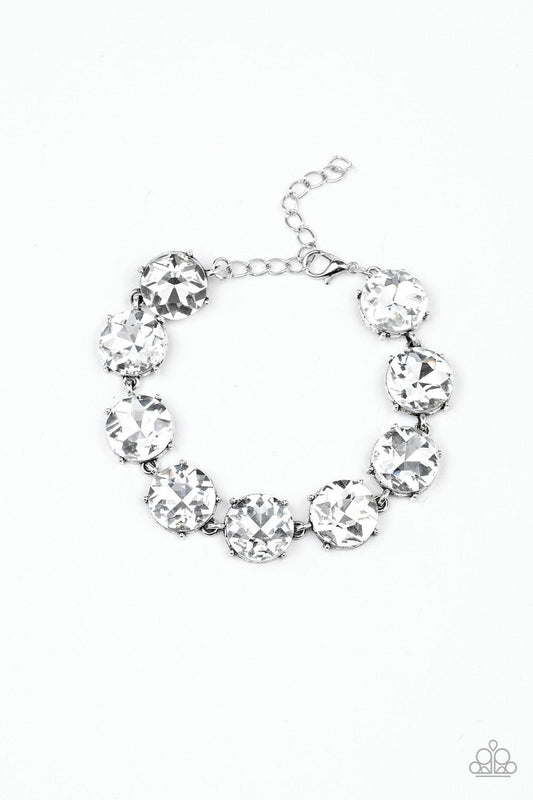 Paparazzi Accessories Fabulously Flashy - White Nestled inside classic silver fittings, a collection of oversized white rhinestones delicately link around the wrist for a flashy finish. Features an adjustable clasp closure. Sold as one individual bracelet