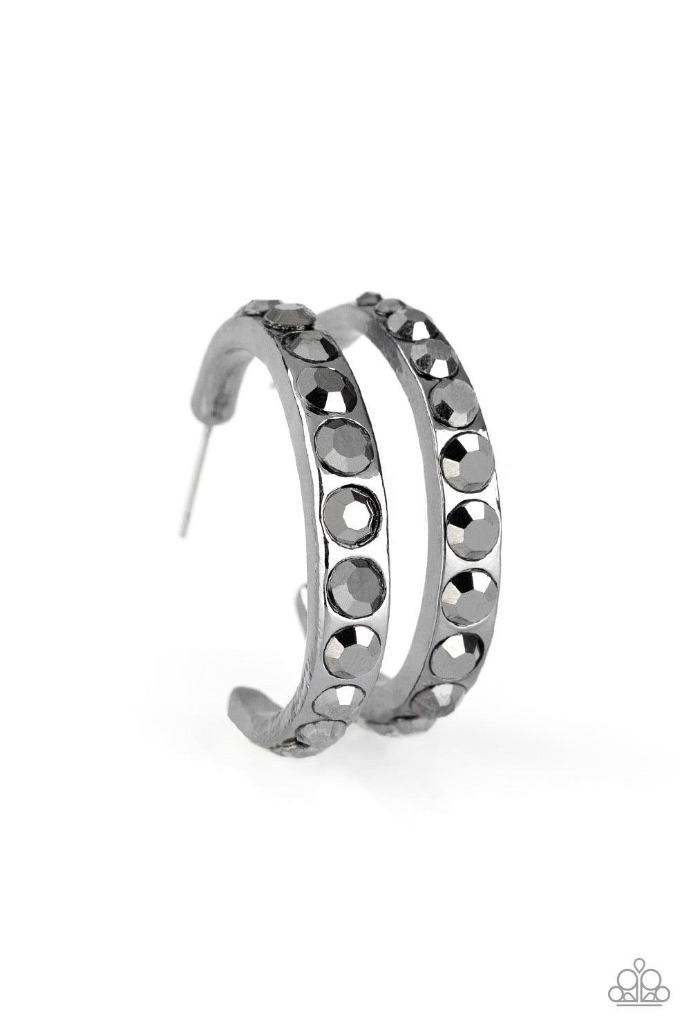 Paparazzi Accessories Welcome To Glam Town ~Black Gradually increasing in size near the center, glassy hematite rhinestones are encrusted down the spine of a dainty gunmetal hoop for a grunge-glamorous look. Earring attaches to a standard post fitting. Ho