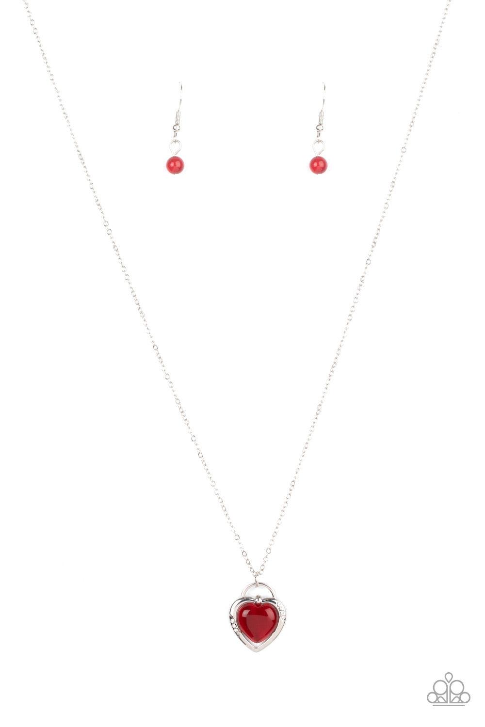 Paparazzi Accessories A Dream Is A Wish Your Heart Makes - Red Featuring a red cat's eye stone center, a glistening silver locket inspired frame glides along a dainty silver chain below the collar for a charming look. Sections of dainty white rhinestones