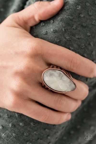 Paparazzi Accessories Magically Mystified - Copper Featuring an asymmetrical cut, a large cloudy faux stone bead is pressed into an asymmetrical copper frame that is held up by the illusion of flared copper bar fittings. Features a stretchy band for a fle