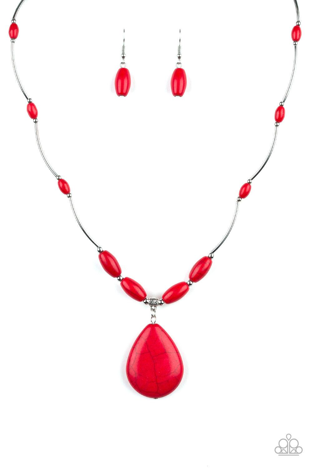 Paparazzi Accessories Explore The Elements - Red A collection of shiny silver beads and fiery red stone beads are threaded along an invisible wire below the collar. A dramatically oversized red stone teardrop pendant swings from the bottom of a seasonal f